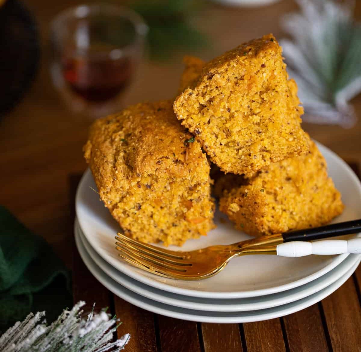 Pieces of Vegan Sweet Potato Maple Herb Cornbread on small plates.