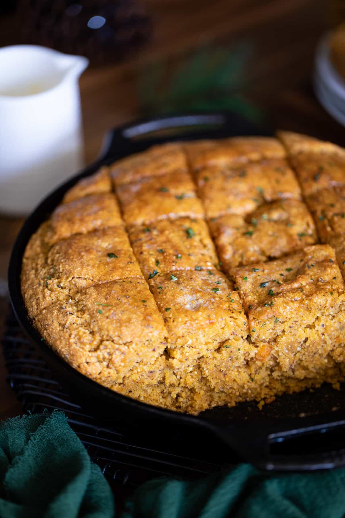 Skillet of sliced Vegan Sweet Potato Maple Herb Cornbread.