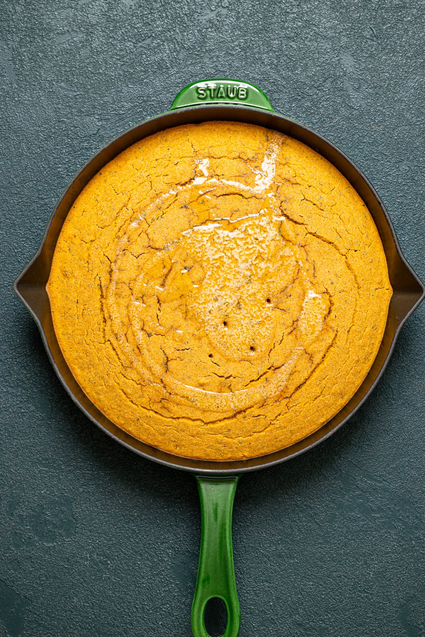 Baked Vegan Sweet Potato Maple Herb Cornbread in a green skillet.