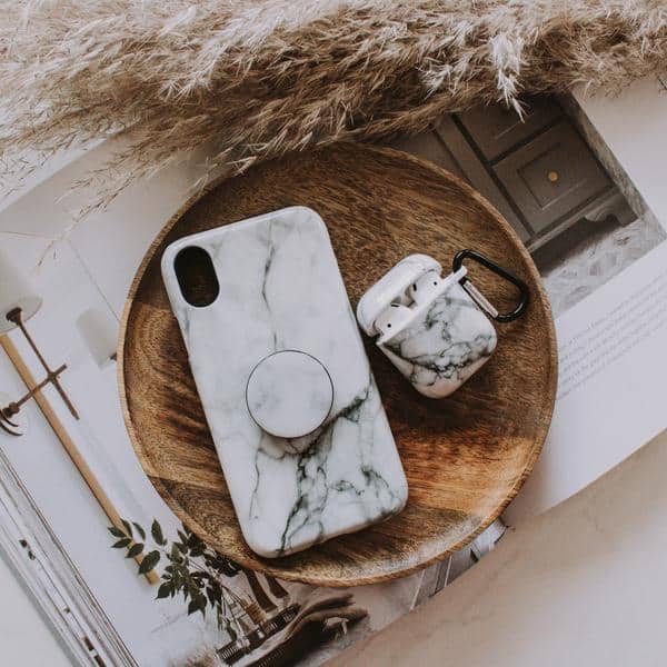 Iphone and airpods in marble cases.