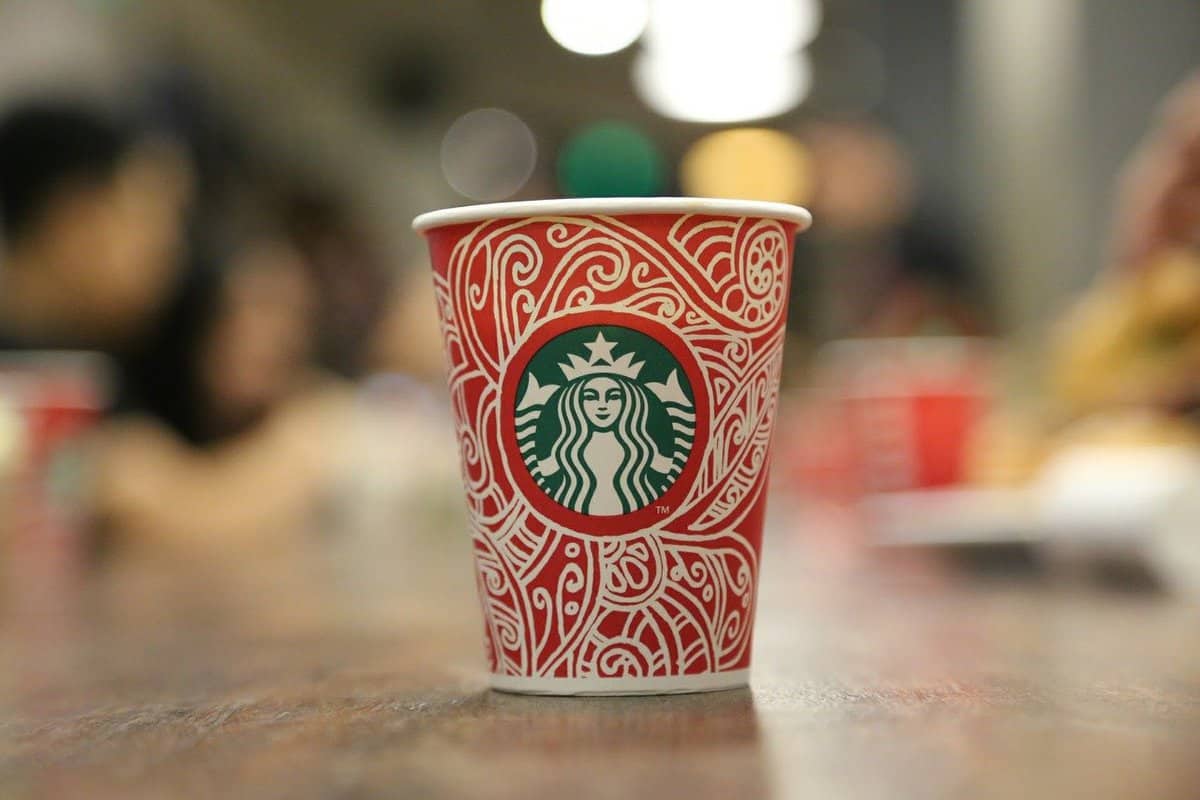 Red, green, and white Starbucks cup.