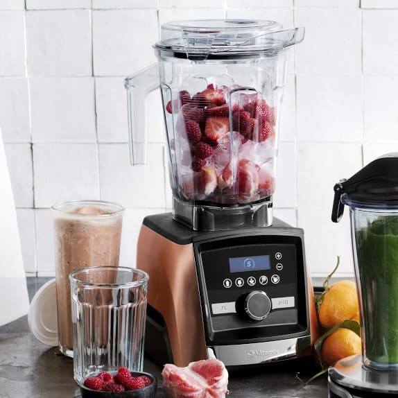 Vitamix blender filled with strawberries and ice.