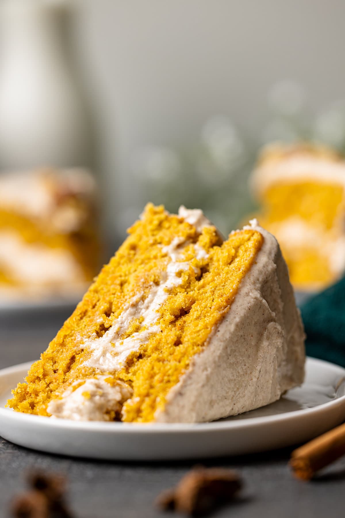 Slice of Carrot Cake with Chai Buttercream lying down on a plate