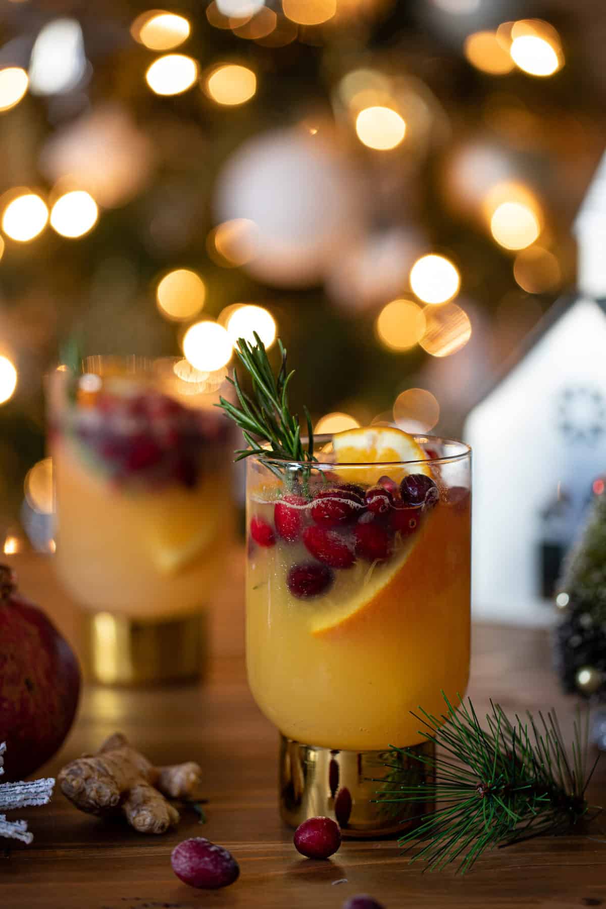 Two small glasses of Sparkling Cranberry Orange Ginger Mocktail.