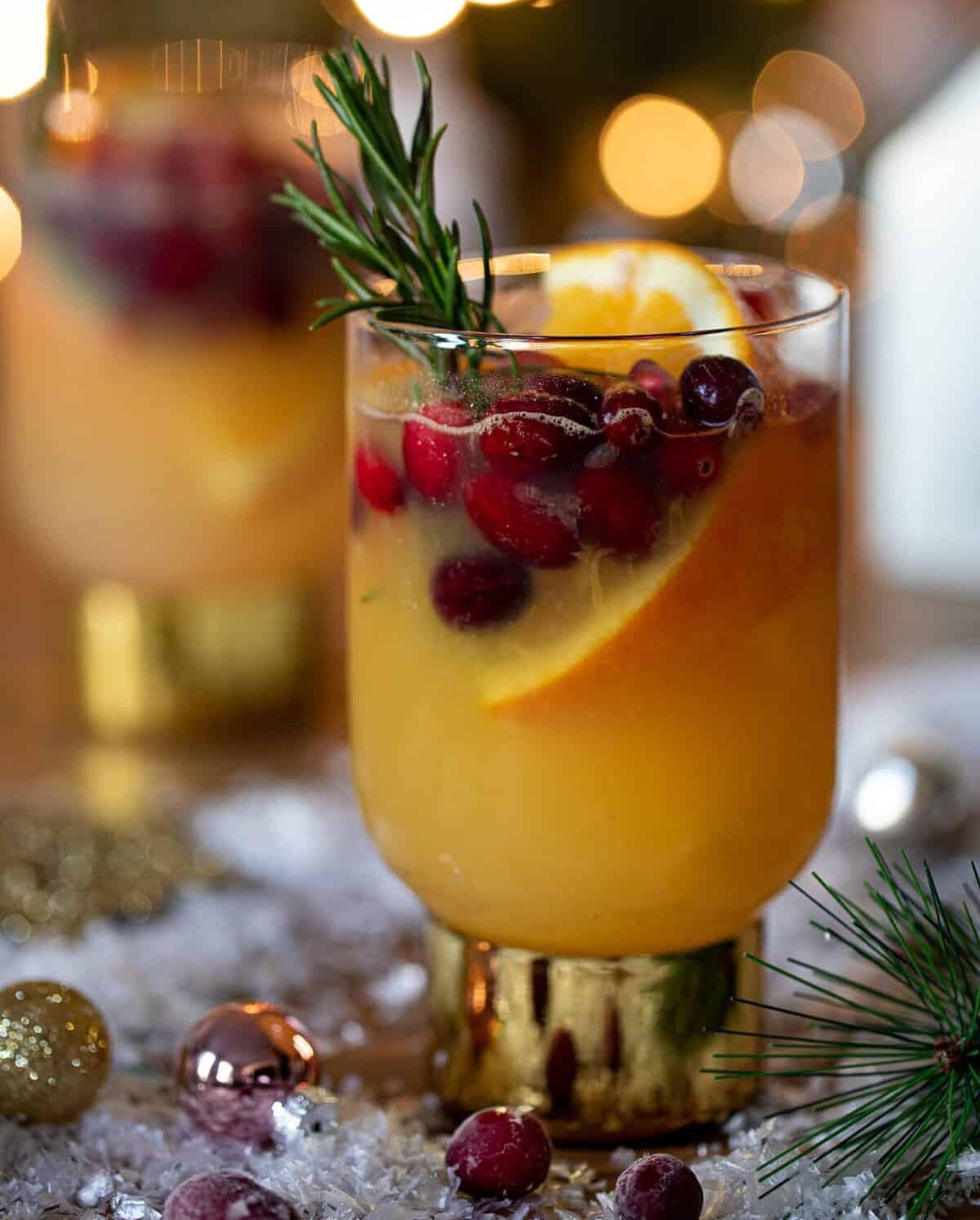 Sparkling Cranberry Orange Ginger Mocktail in a small glass with a golden base