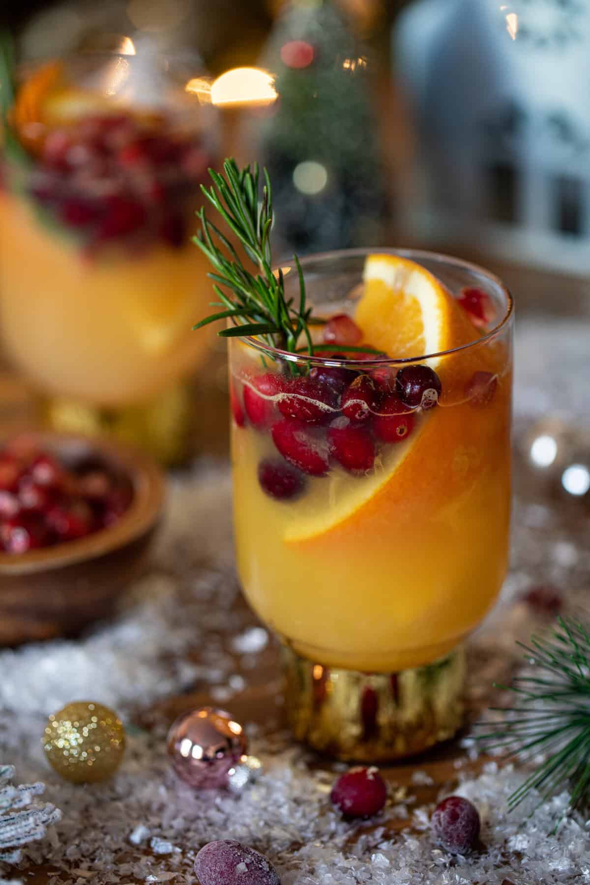 Sparkling Cranberry Orange Ginger Mocktail in a gold-stemmed glass.