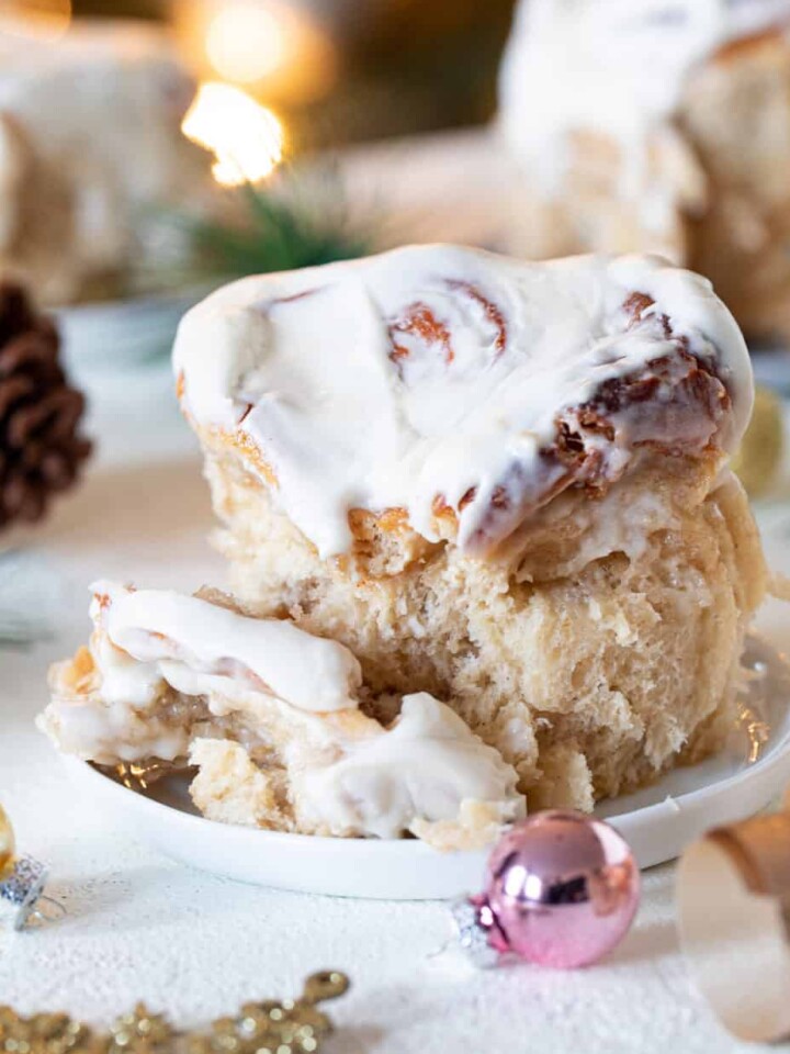 Fluffy Apple Butter Eggnog Cinnamon Roll on a small plate.