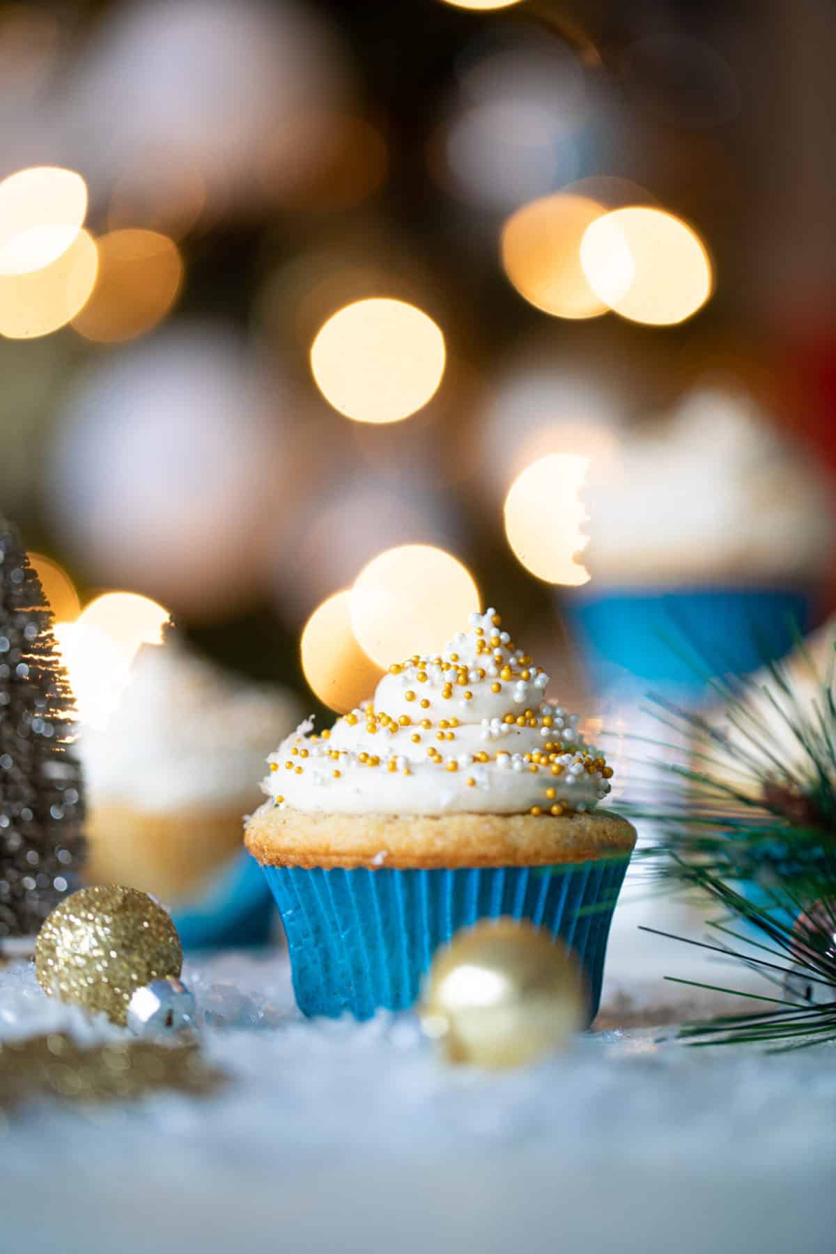 Eggnog Cupcake with Cream Cheese Frosting in a blue muffin-liner.