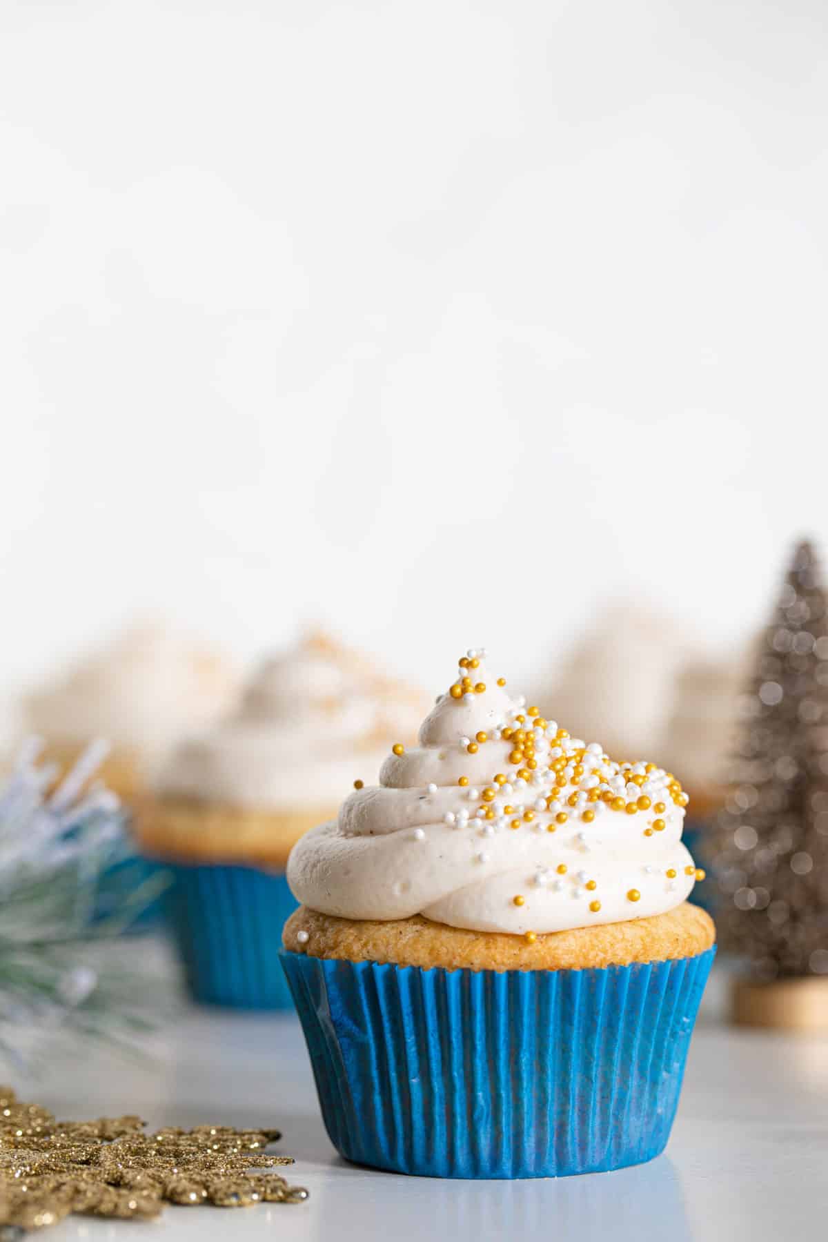 Eggnog Cupcakes with Cream Cheese Frosting topped with sprinkles.