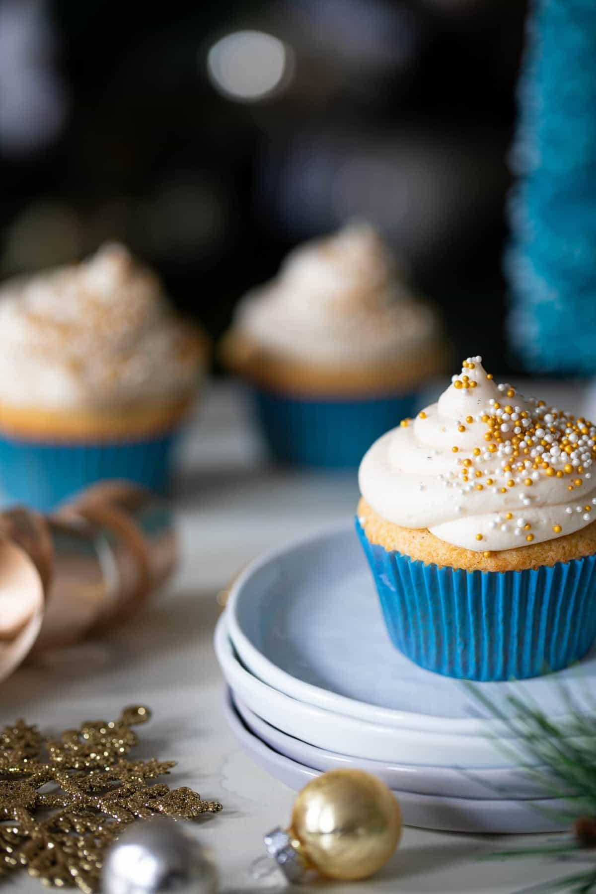 Eggnog Cupcake with Cream Cheese Frosting on small, stacked plates.