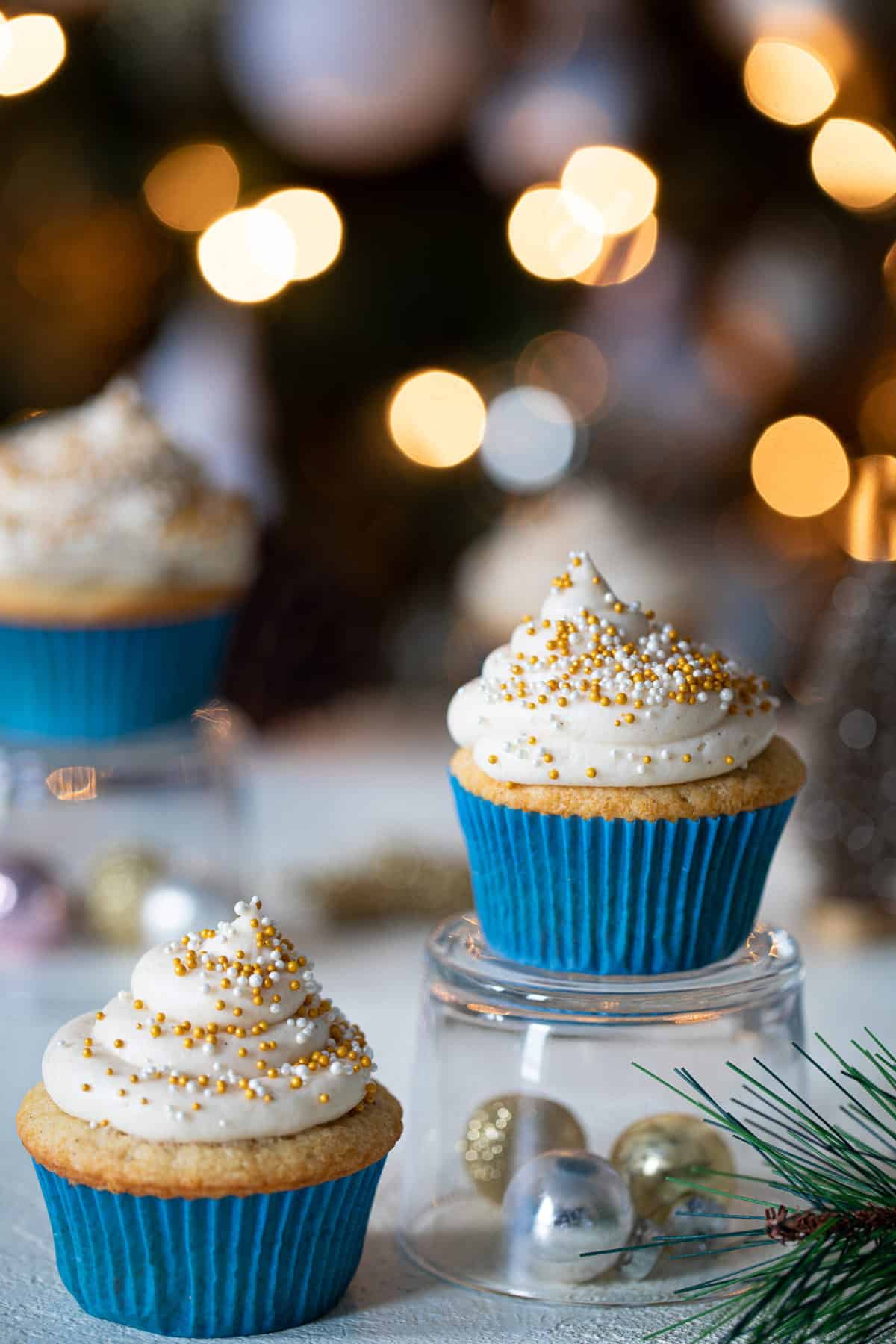 Eggnog Cupcake with Cream Cheese Frosting on an upside down glass.