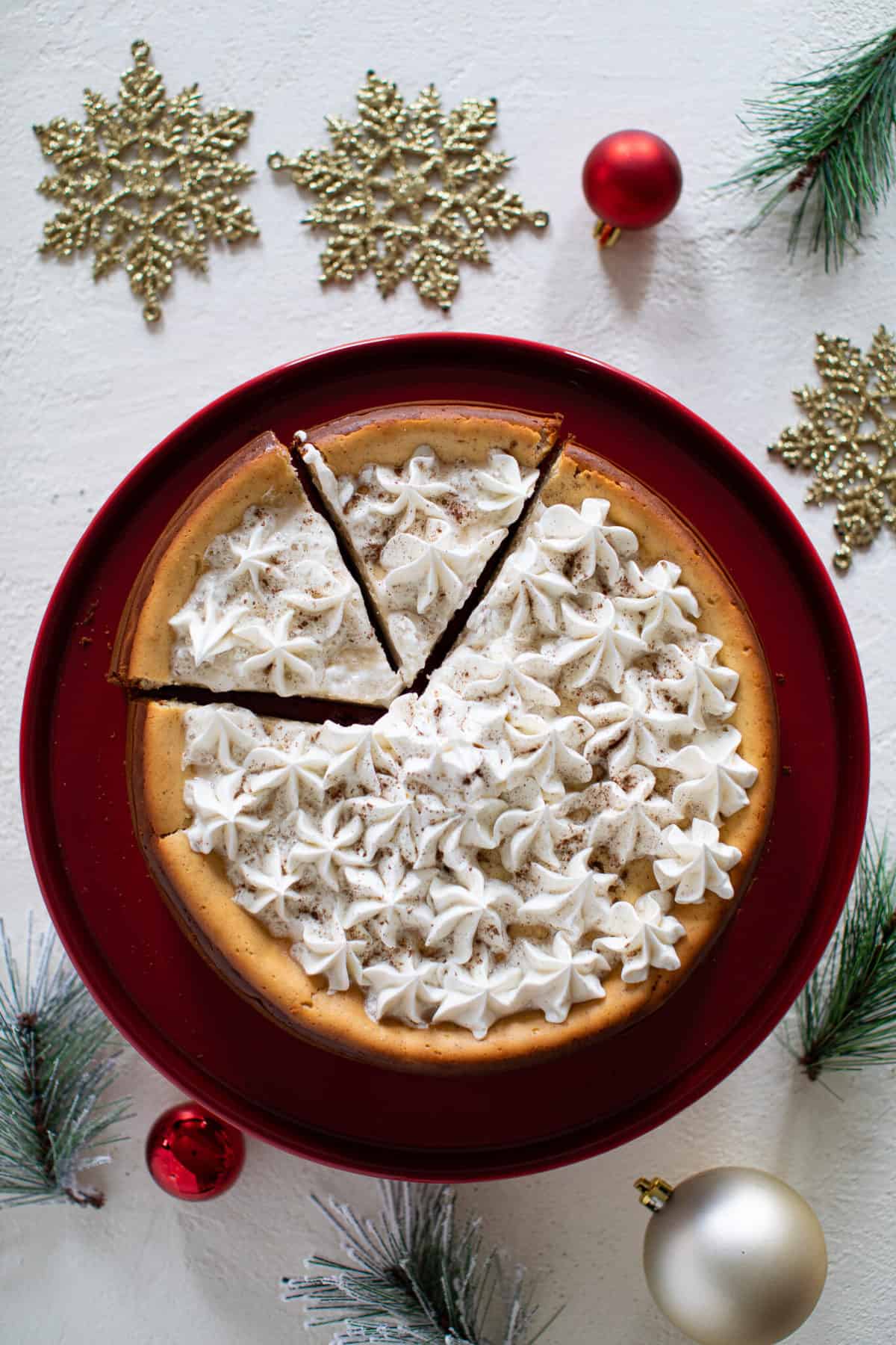 Two slices cut from a Spiced Chai Cheesecake with Gingersnap Crust.