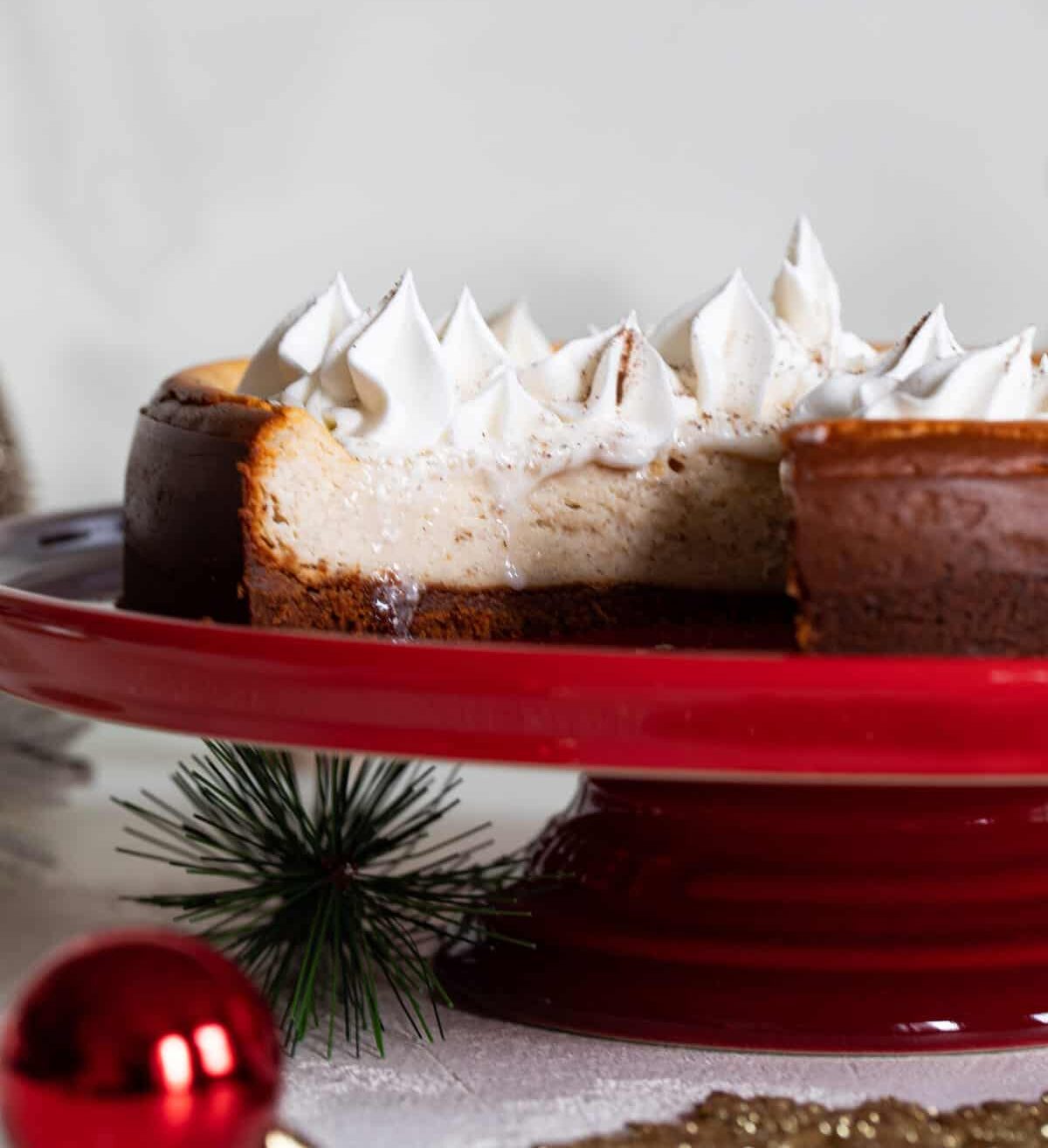 Spiced Chai Cheesecake with a Gingersnap Crust on a red platter.