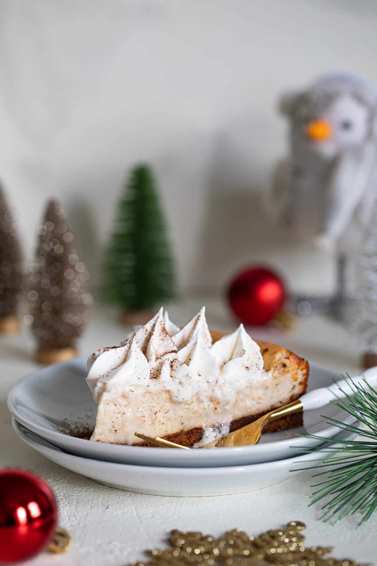 Slice of Spiced Chai Cheesecake with Gingersnap Crust on a plate with a fork.