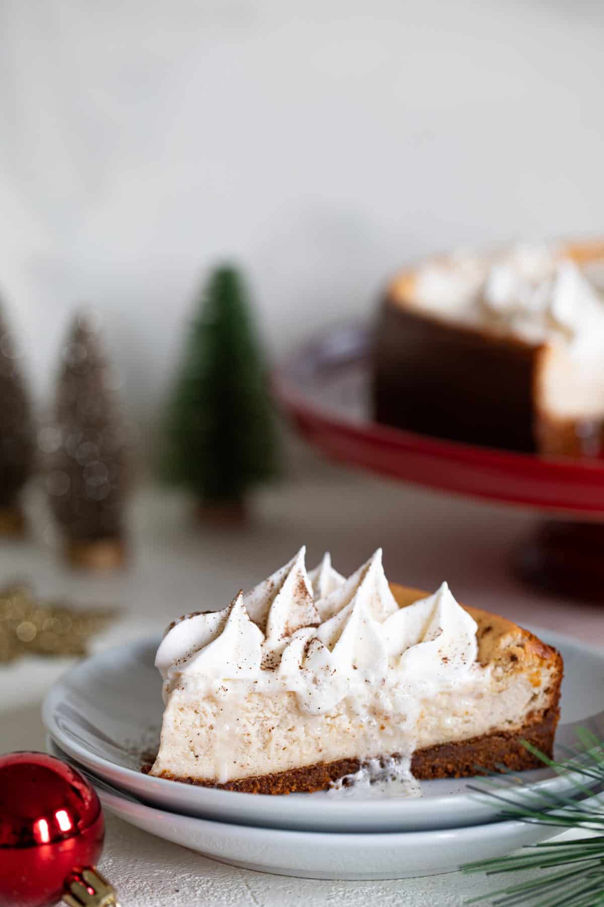 Slice of Spiced Chai Cheesecake with Gingersnap Crust on a small plate.