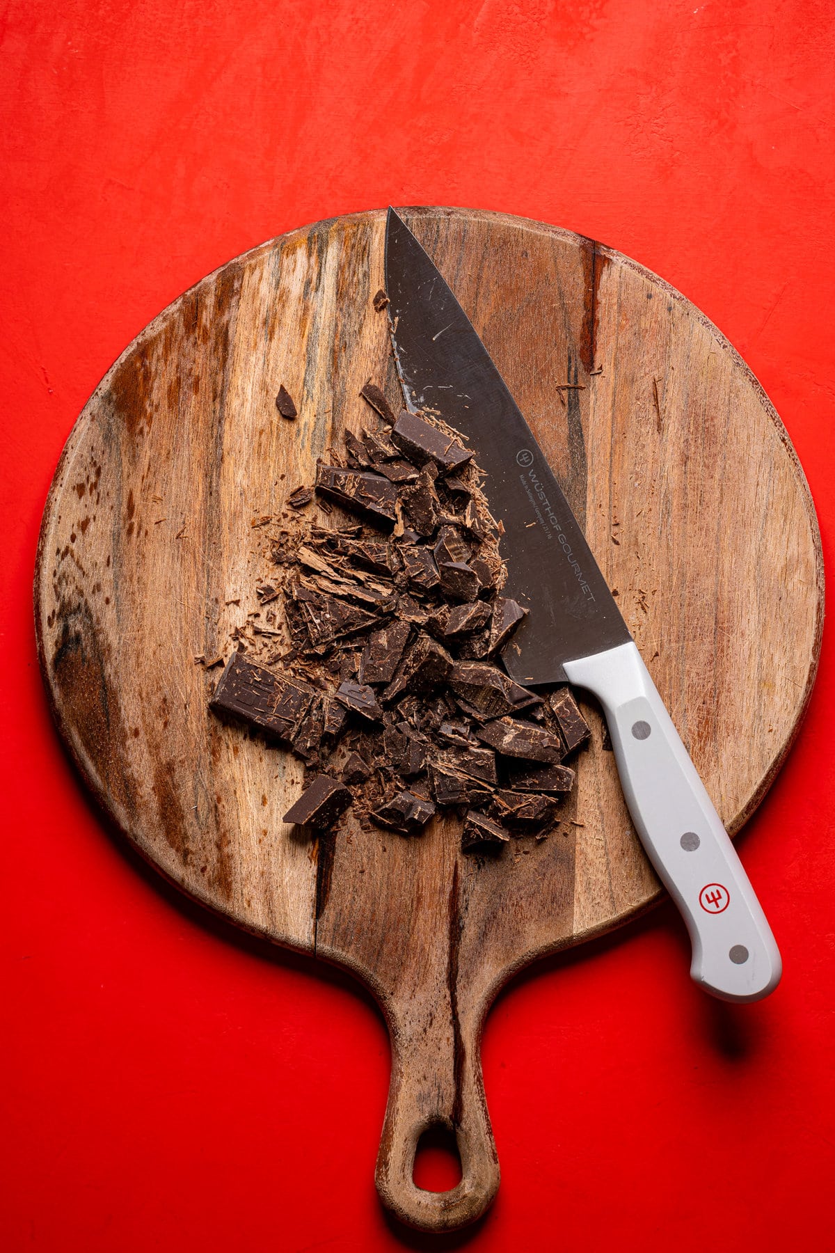 Chopped chocolate on a cutting board with a knife