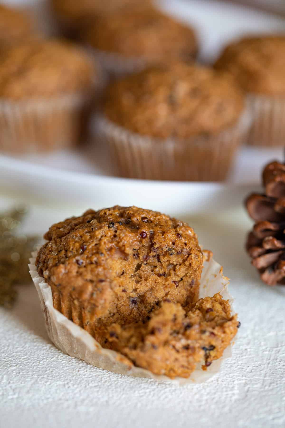 Vegan Gingerbread Quinoa Muffin with a piece pulled off.