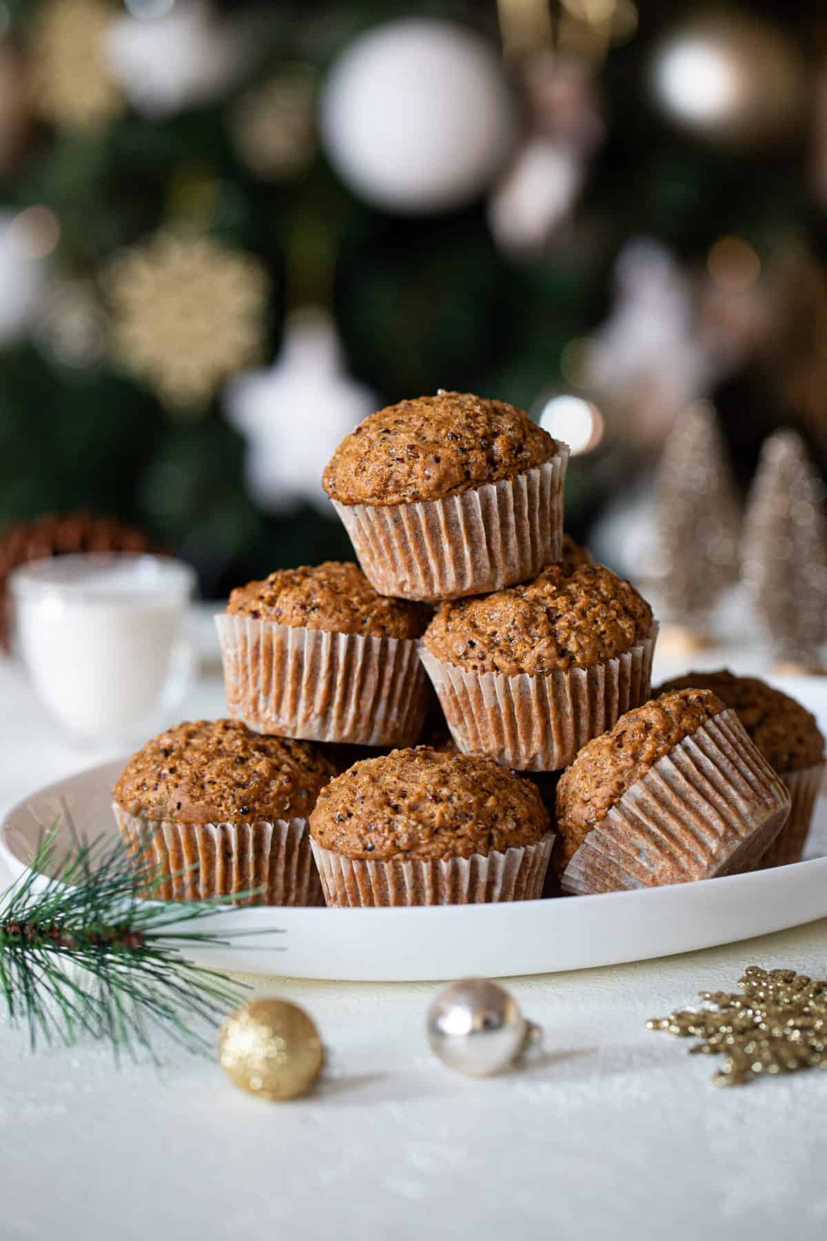 Vegan Gingerbread Quinoa Muffins piled on a white plate.