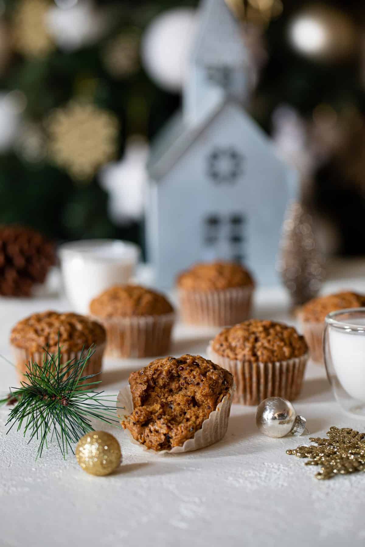 Vegan Gingerbread Quinoa Muffins on a table with Christmas decorations.