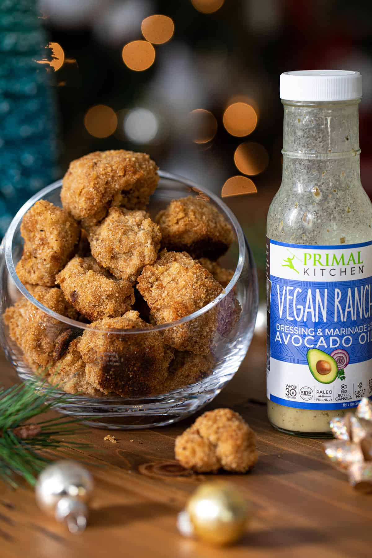 Crispy Vegan Ranch Popcorn Cauliflower Bites next to a jar of Primal Kitchen vegan ranch.