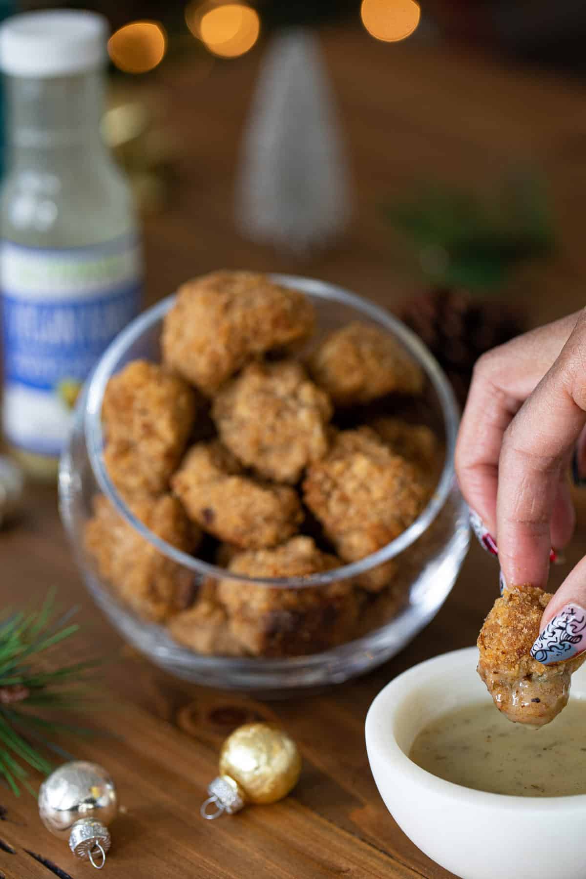 Woman dipping a Crispy Vegan Ranch Popcorn Cauliflower Bite.