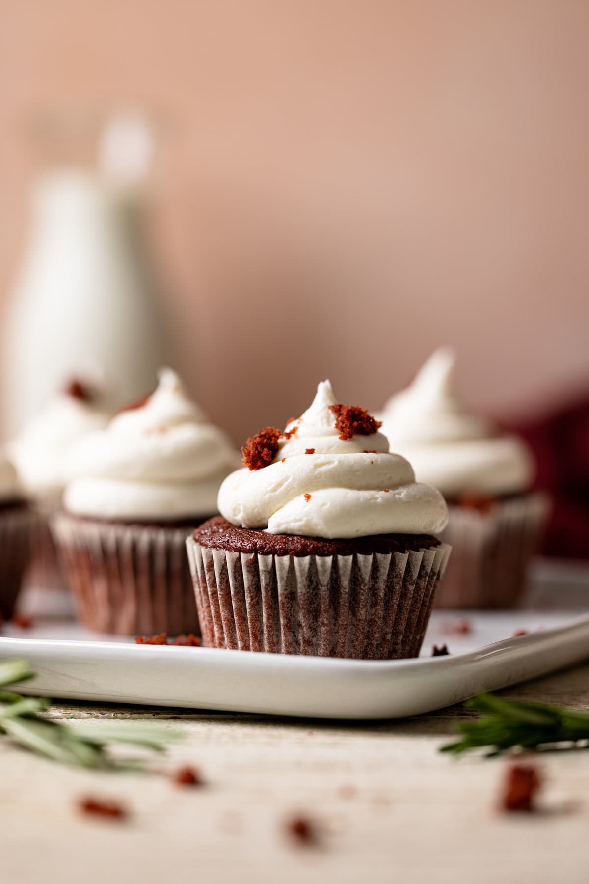 White dish of Vegan Red Velvet Cupcakes with Bourbon Vanilla Buttercream.