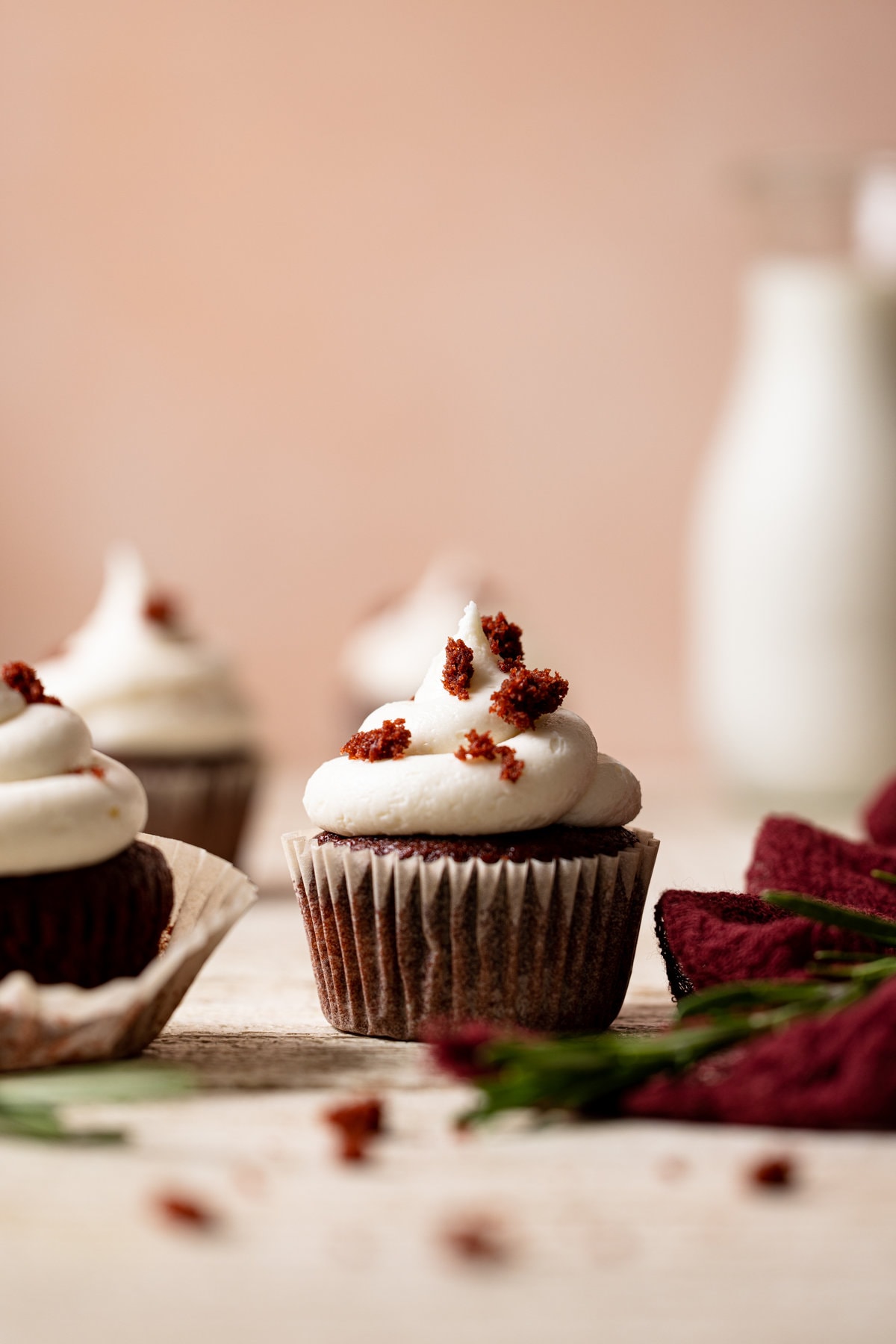 Vegan Red Velvet Cupcakes with Bourbon Vanilla Buttercream on a table.