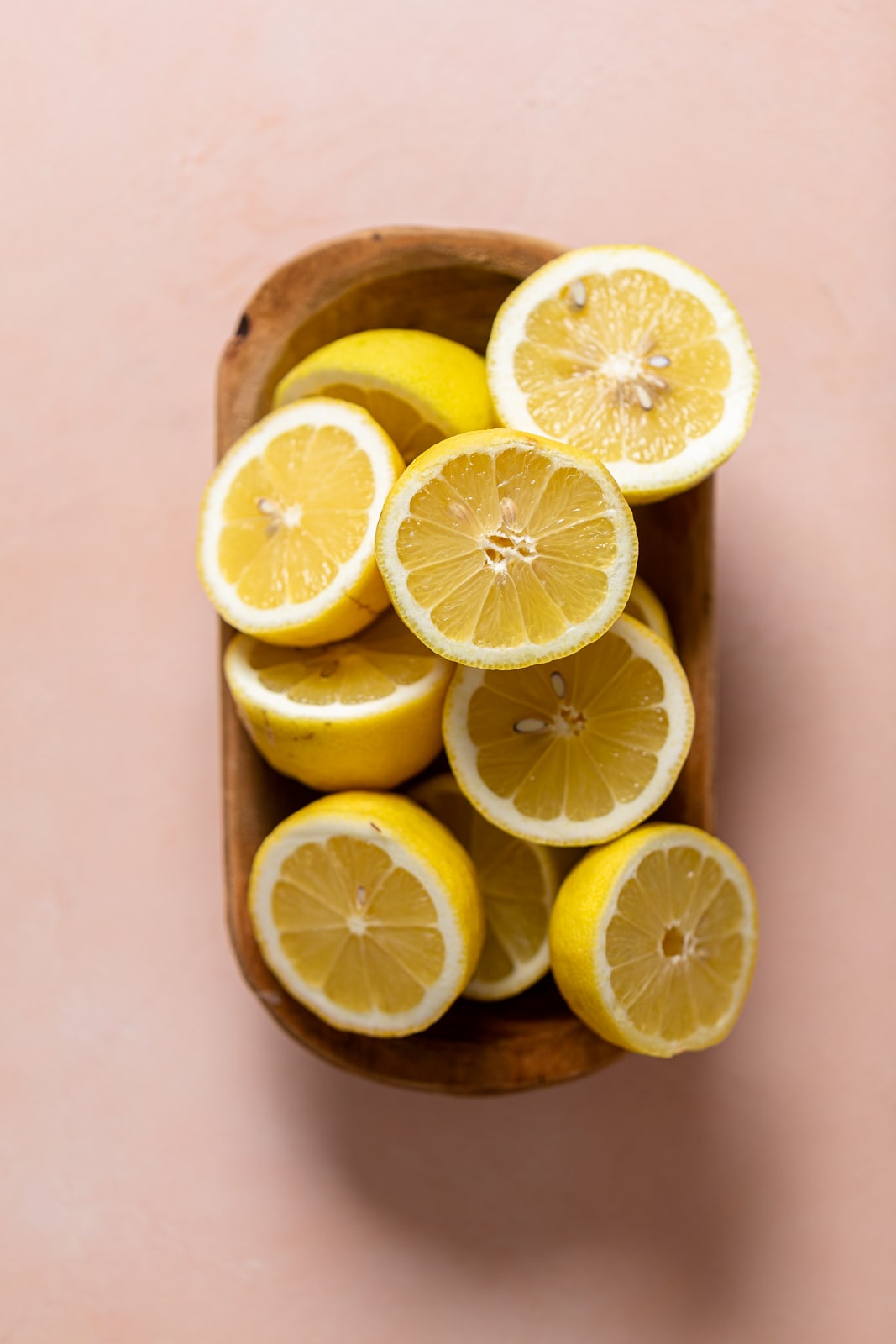 Wooden bowl of lemon halves