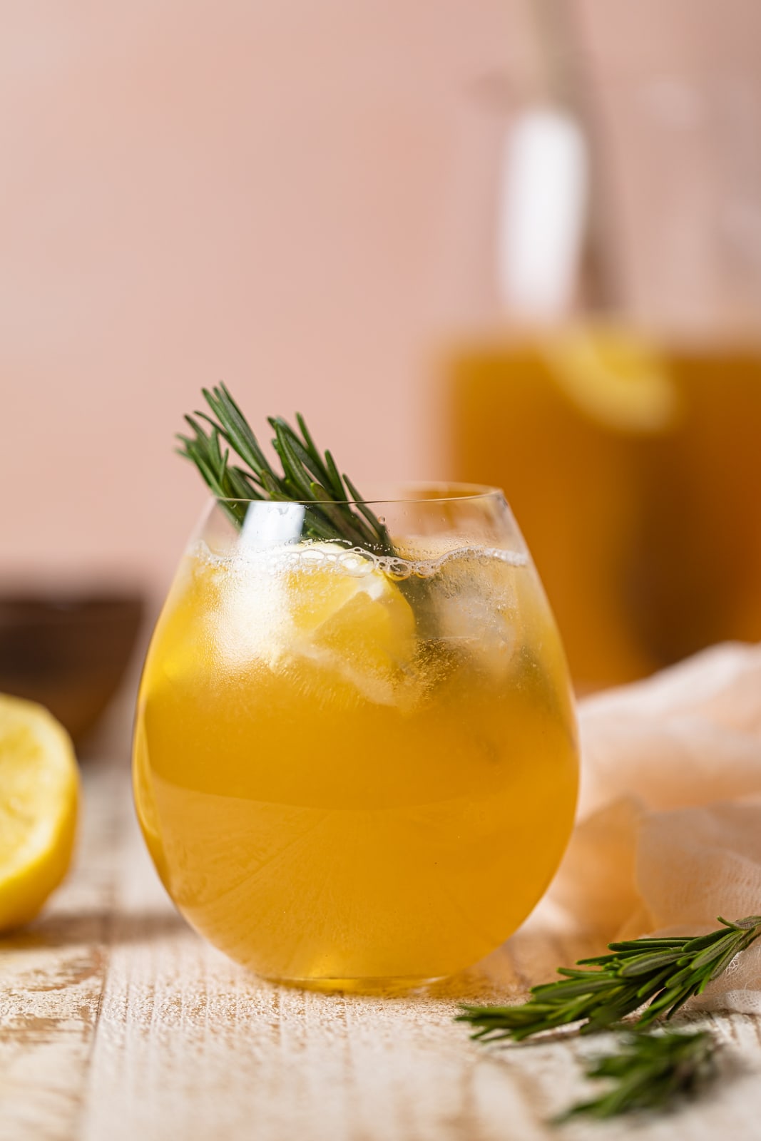 Glass of Apple Cider Vinegar Detox Lemonade with rosemary sprigs