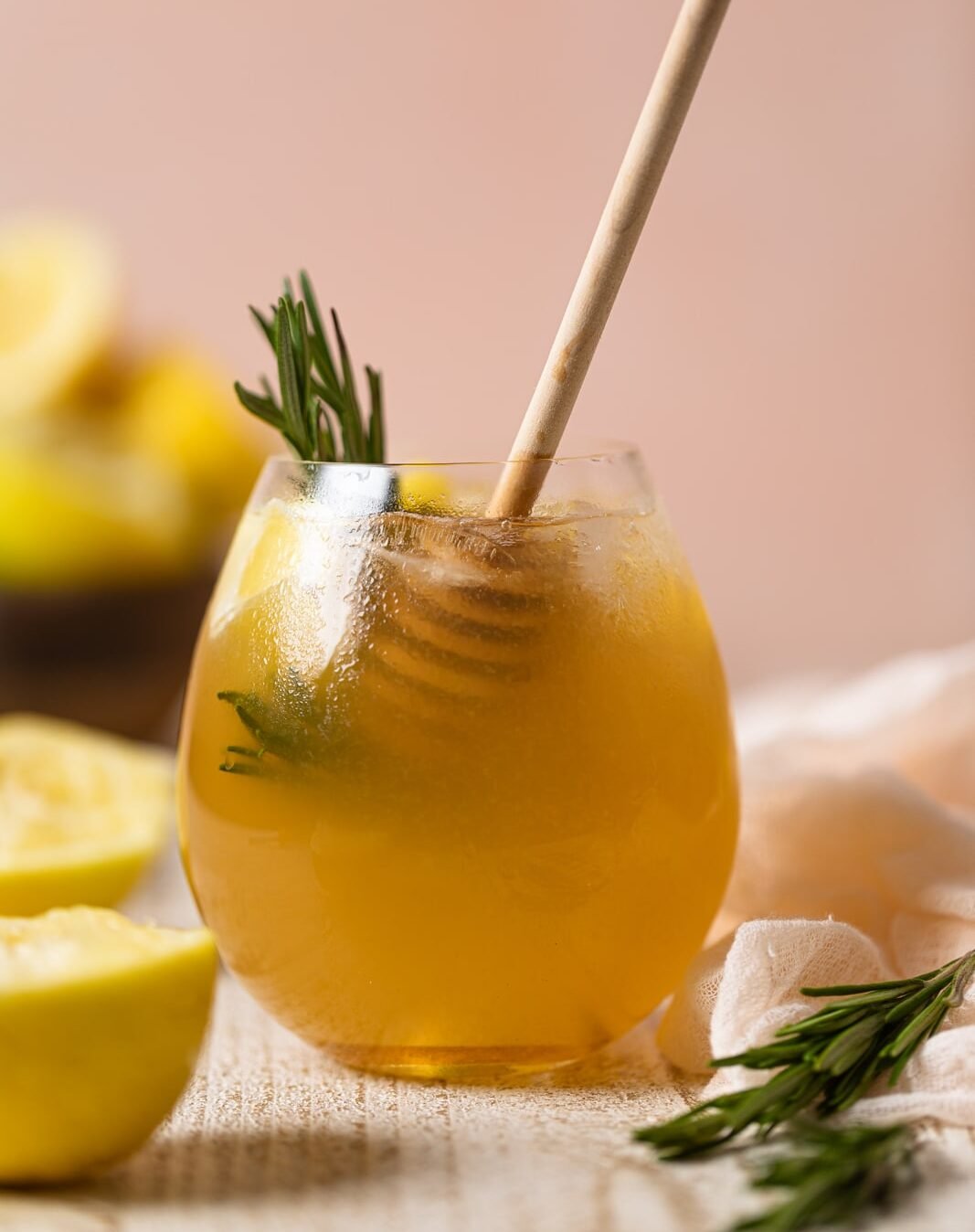 Glass of Apple Cider Vinegar Detox Lemonade with a honey dipper