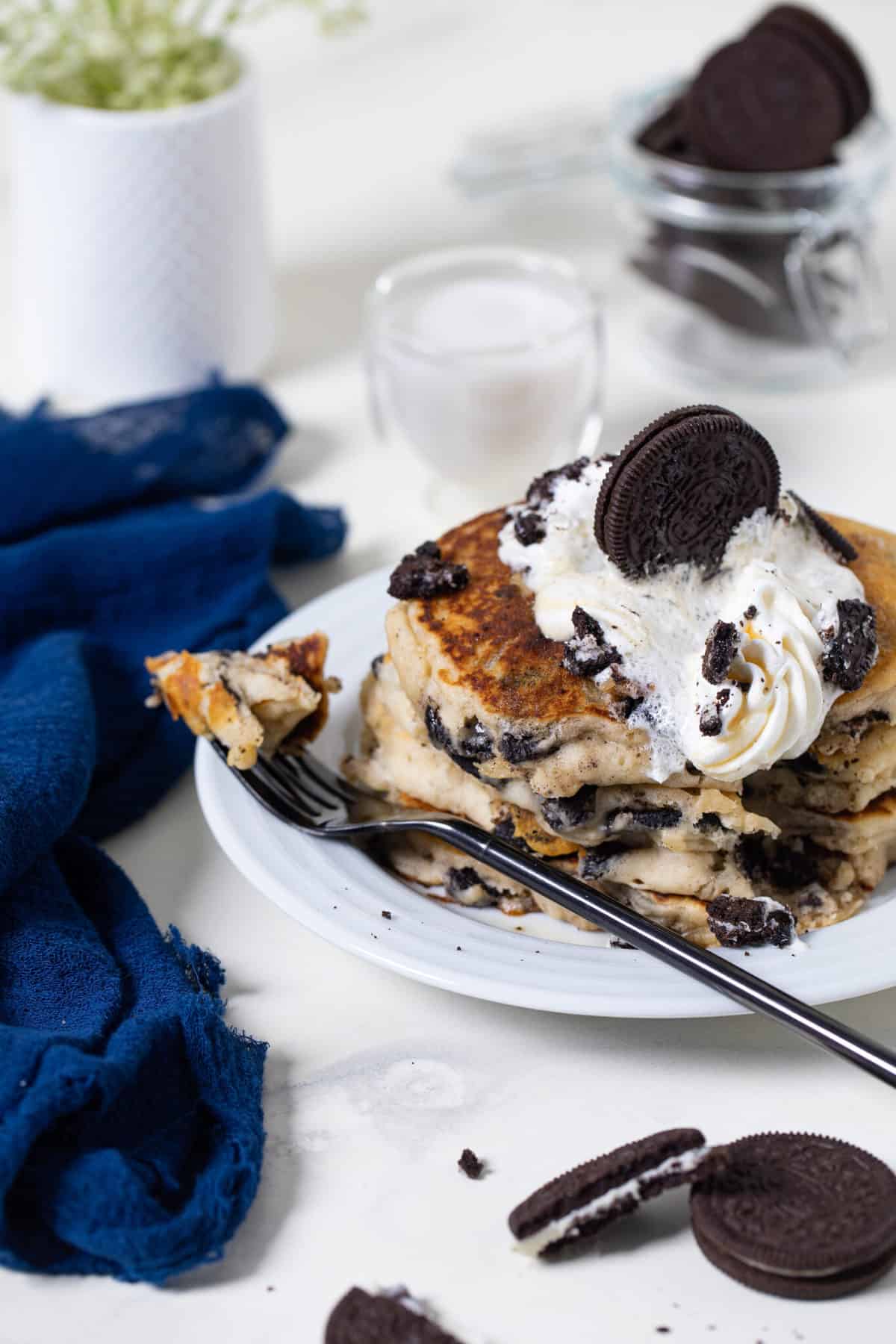 Fork grabbing a piece of  Fluffy Vegan Oreo Pancake.