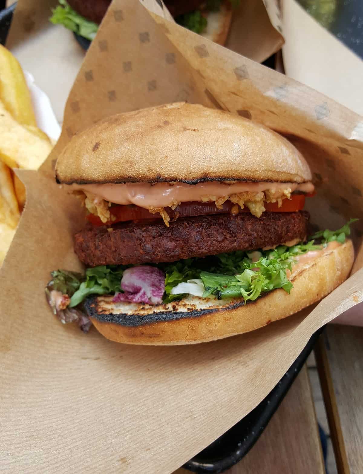 Vegan burger in a paper wrapper.