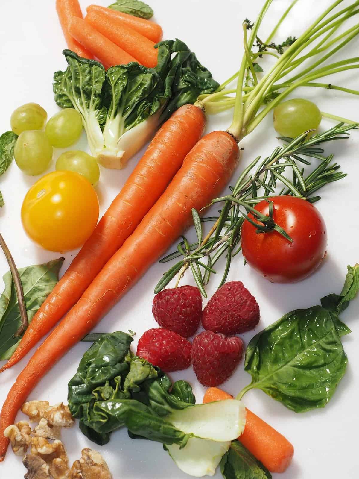 Colorful fruits and vegetables on a white table.