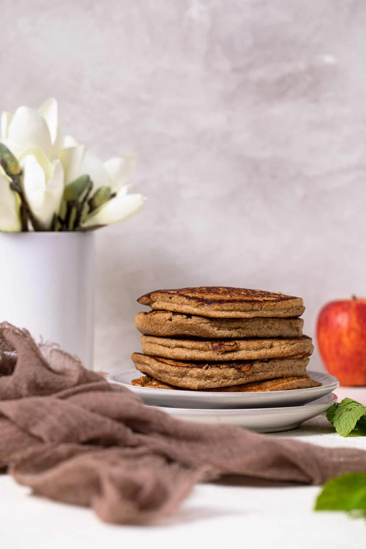 Flourless Apple Pancakes stack on two small plates.