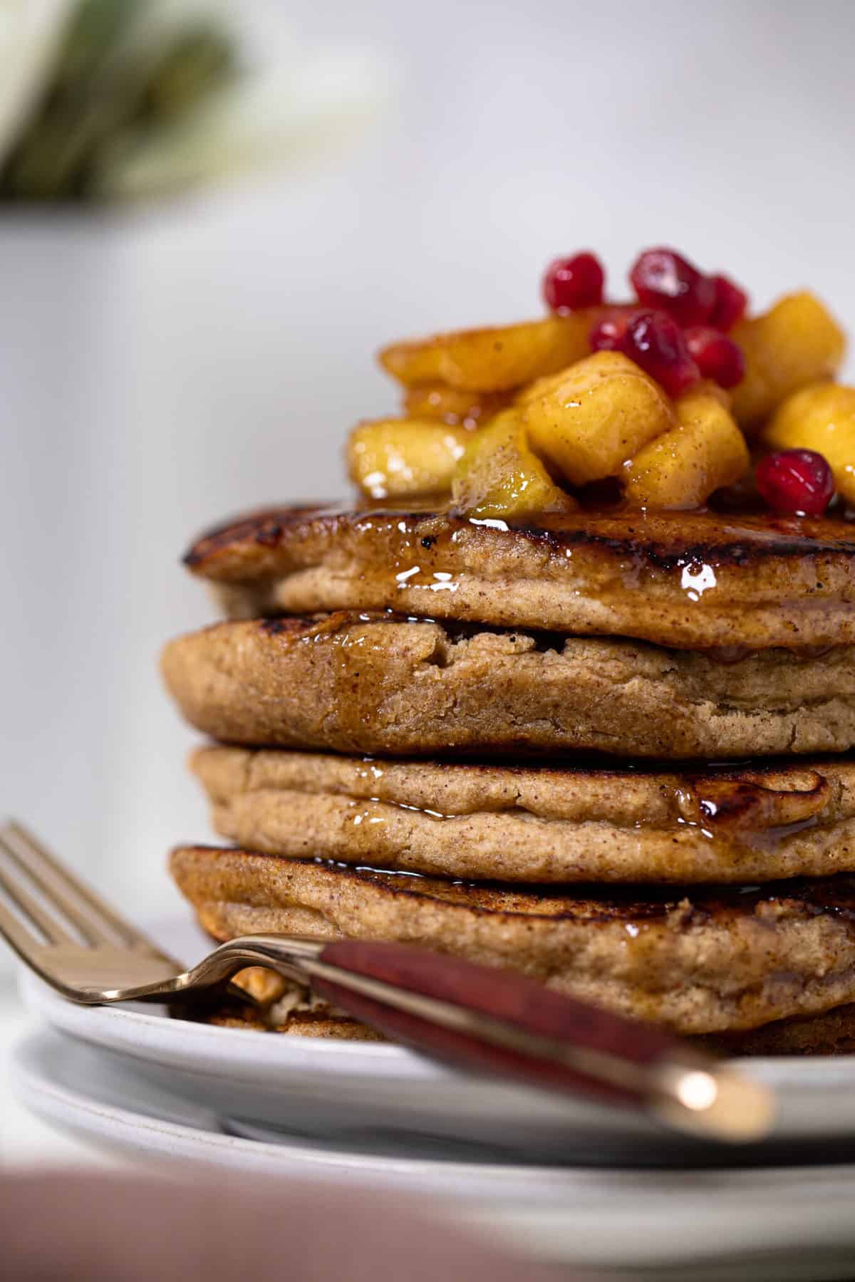 Flourless Apple Pancakes topped with fruit and syrup.