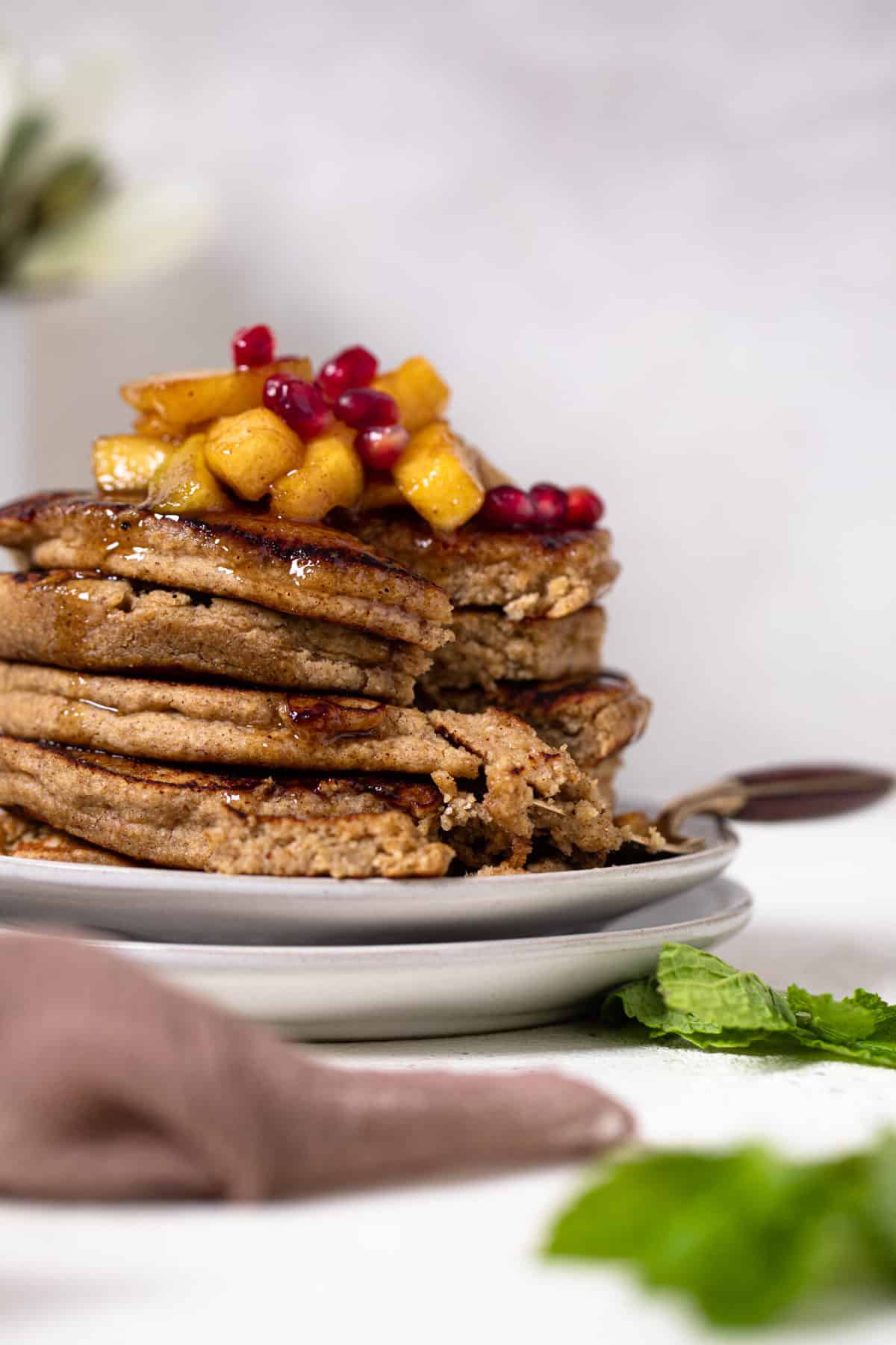 Fork taking a bite from a stack of Flourless Apple Pancakes.