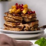 Flourless Apple Pancakes stacked on two white plates.