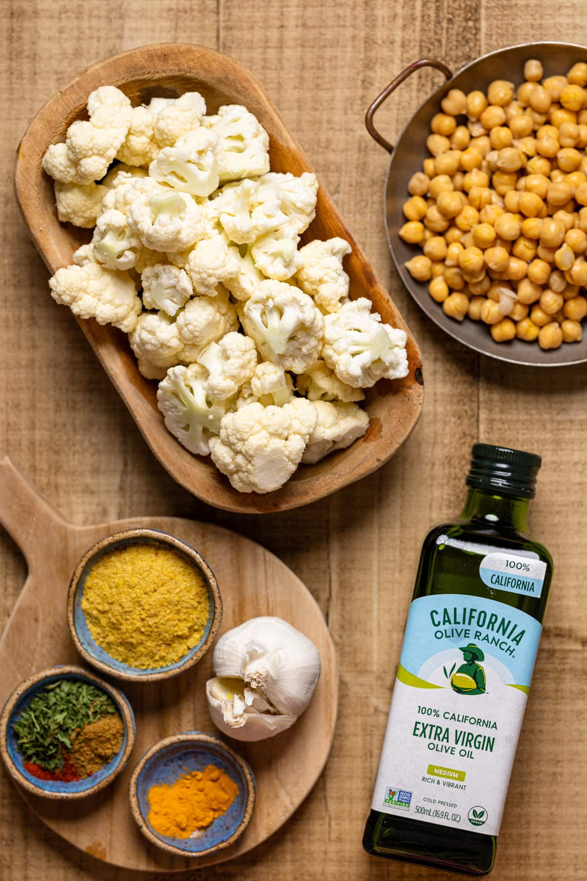 Ingredients for Creamy Roasted Garlic Cauliflower Chickpea Soup including olive oil, chickpeas, and cauliflower