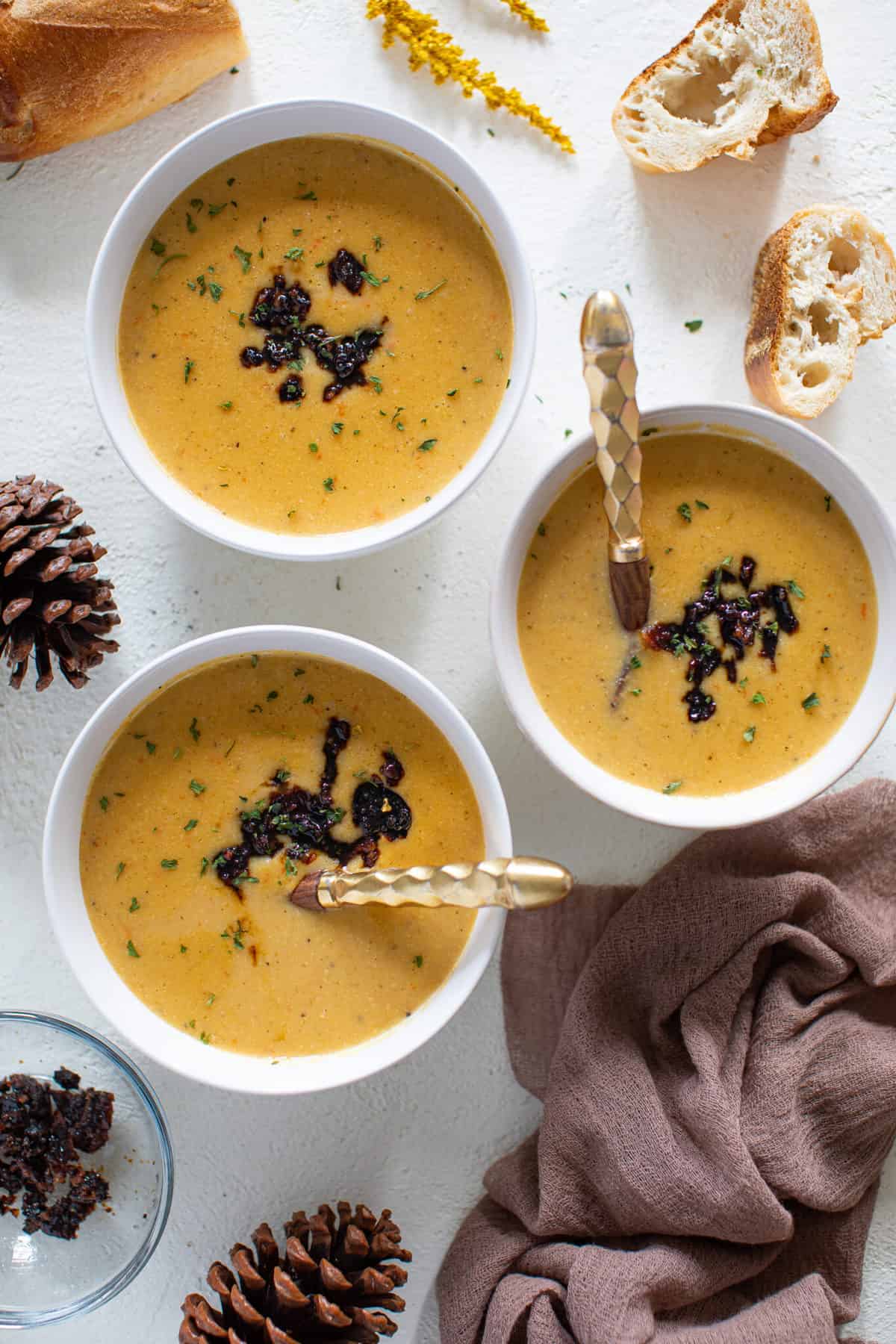 Three bowls of Creamy Roasted Garlic Cauliflower Chickpea Soup