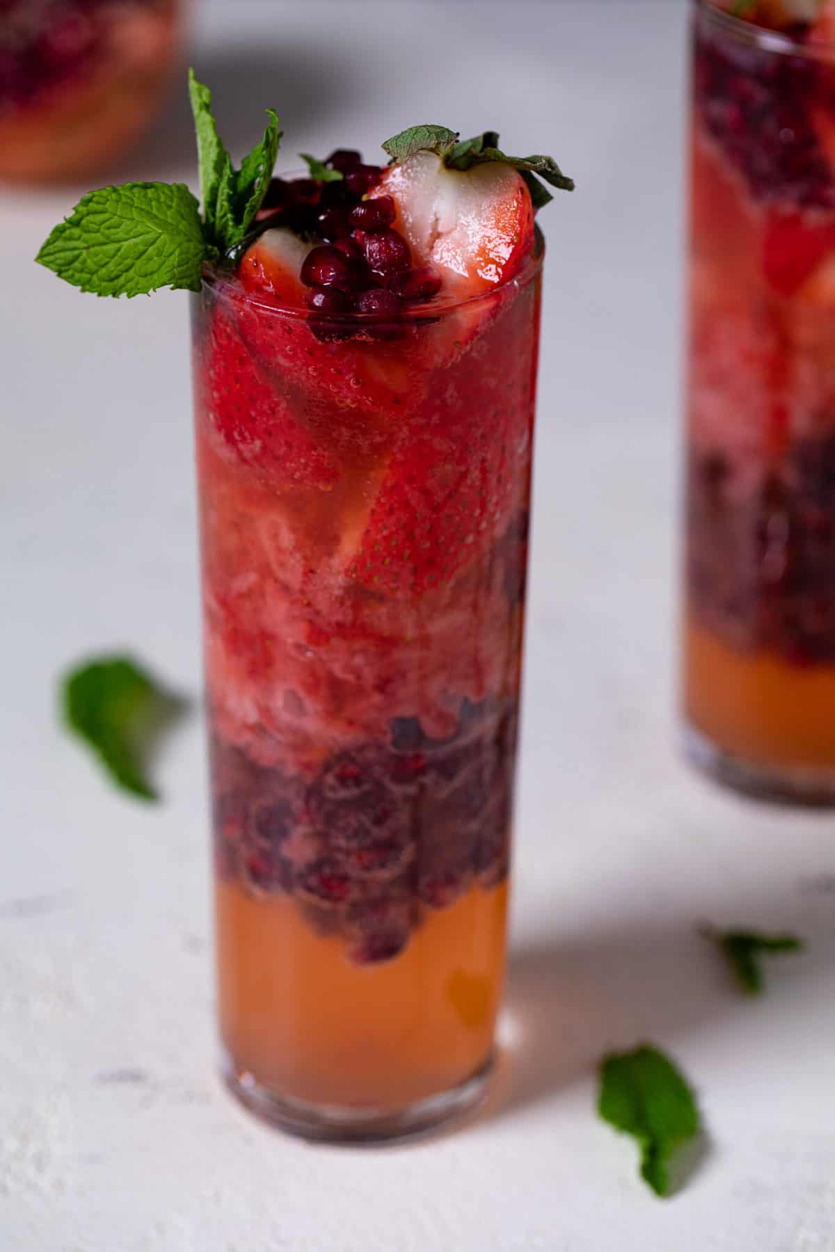 Ginger Strawberry Pomegranate Mocktail stuffed with strawberries and pomegranate seeds.