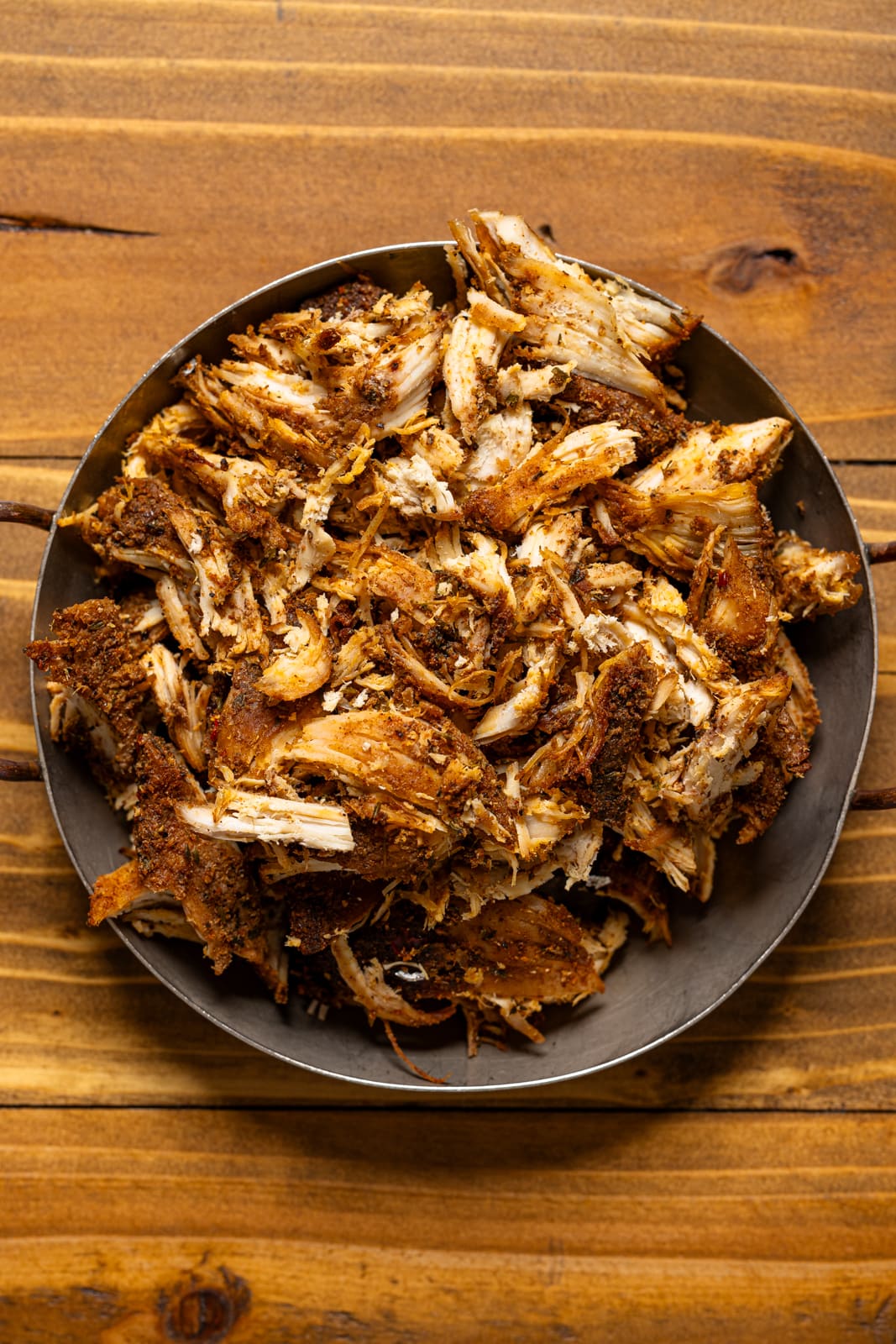 Bowl of shredded jerk chicken.