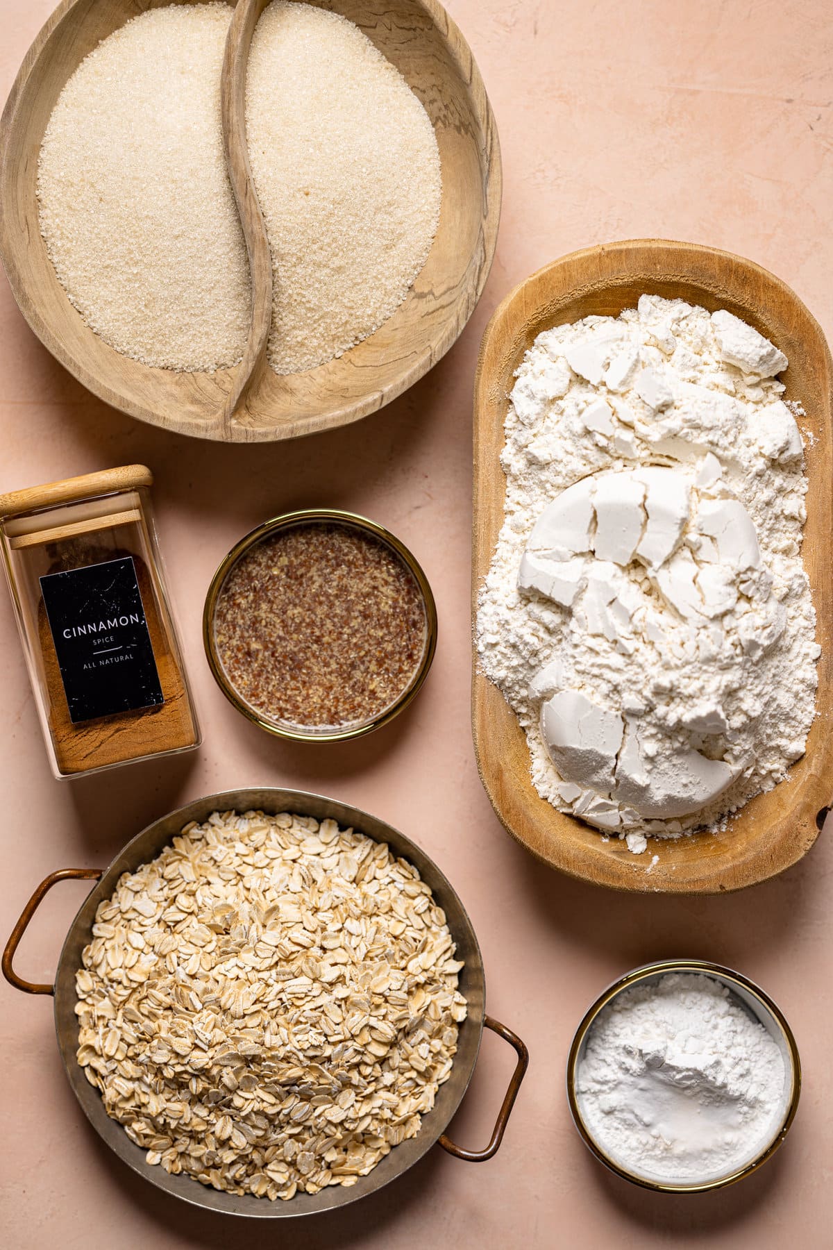 Dry ingredients for Vegan Strawberry Oatmeal Cake including oatmeal, flour, and cinnamon