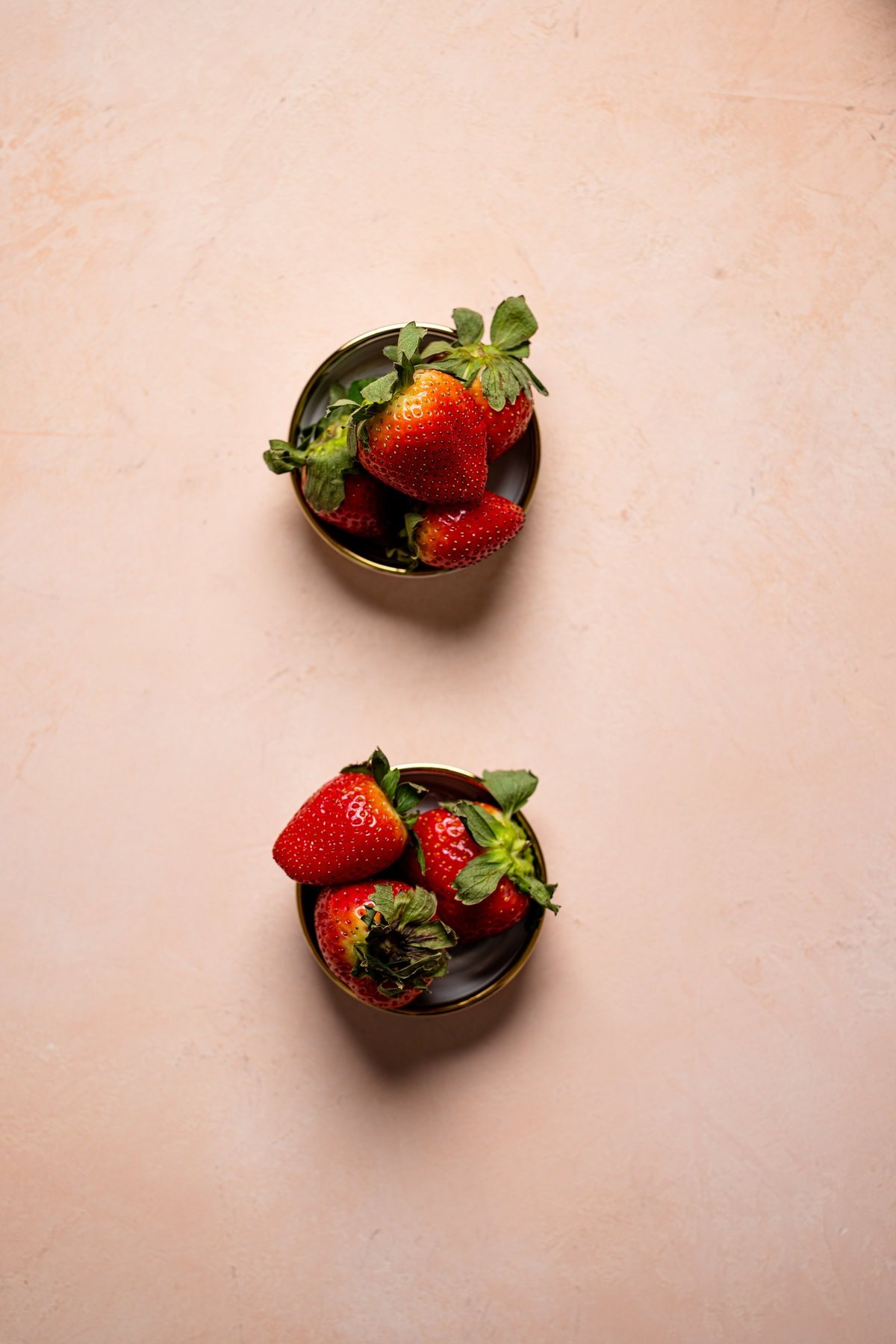 Two sets of strawberries