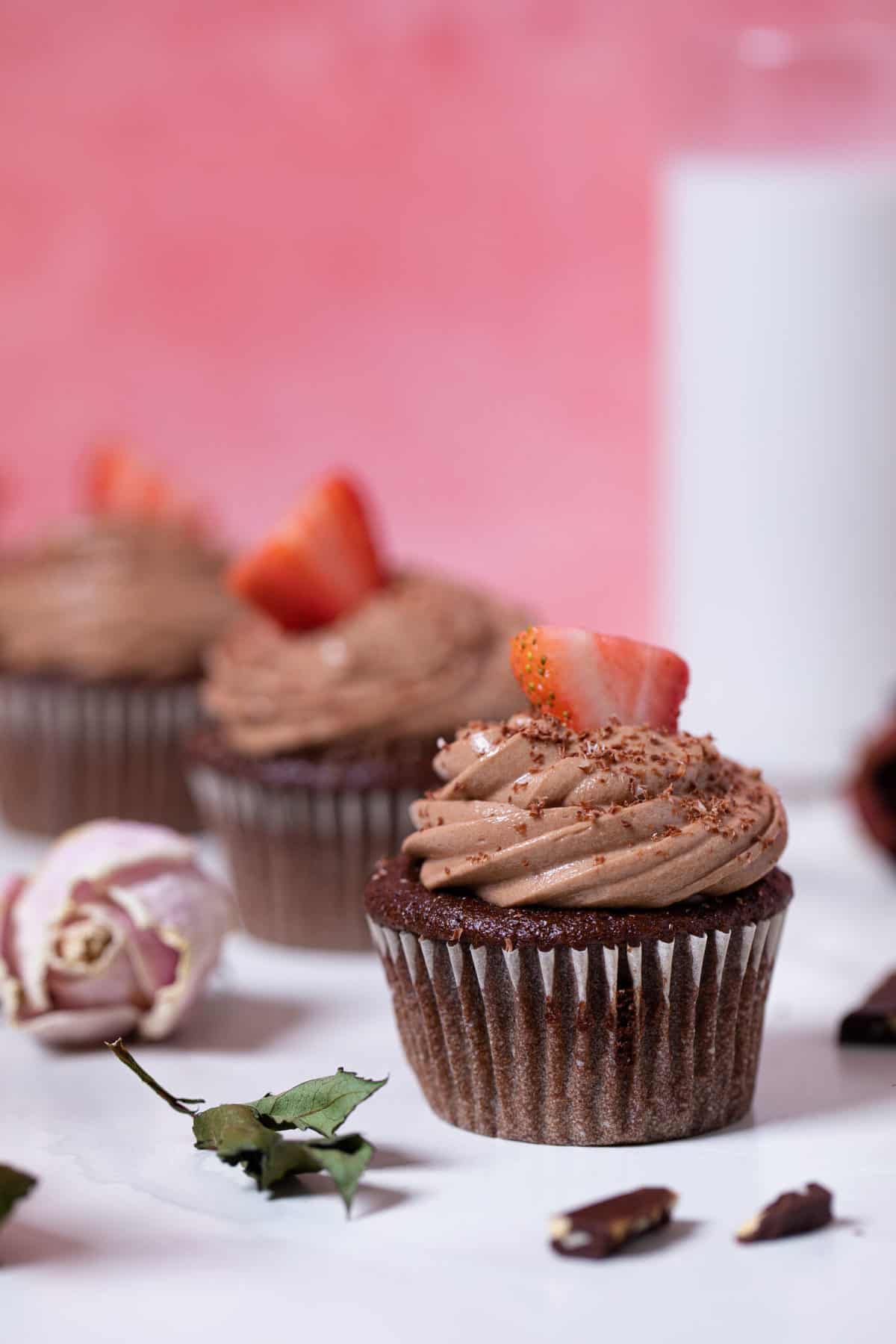 Line of Bailey’s Chocolate Cupcakes on a white table.