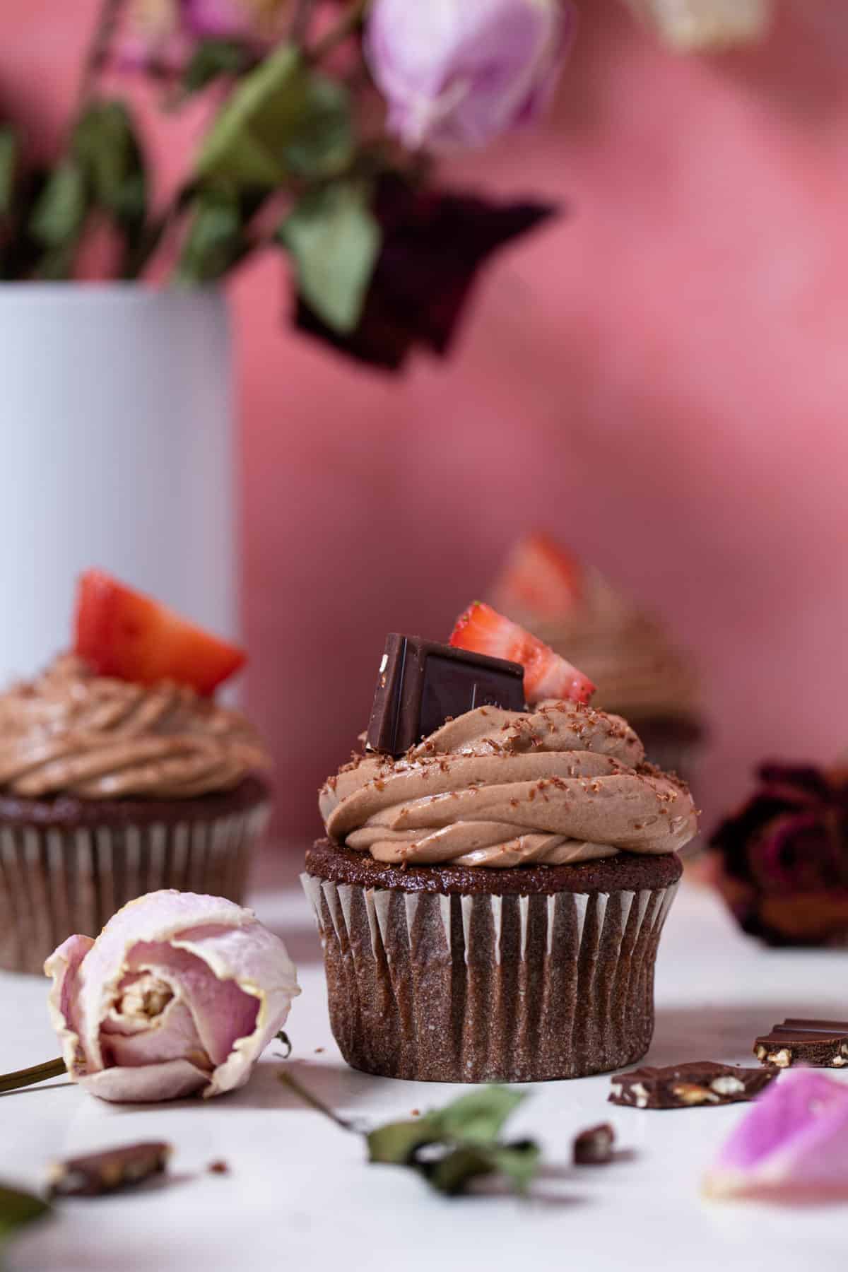 Break Up Bailey’s Chocolate Cupcakes on a table with roses.