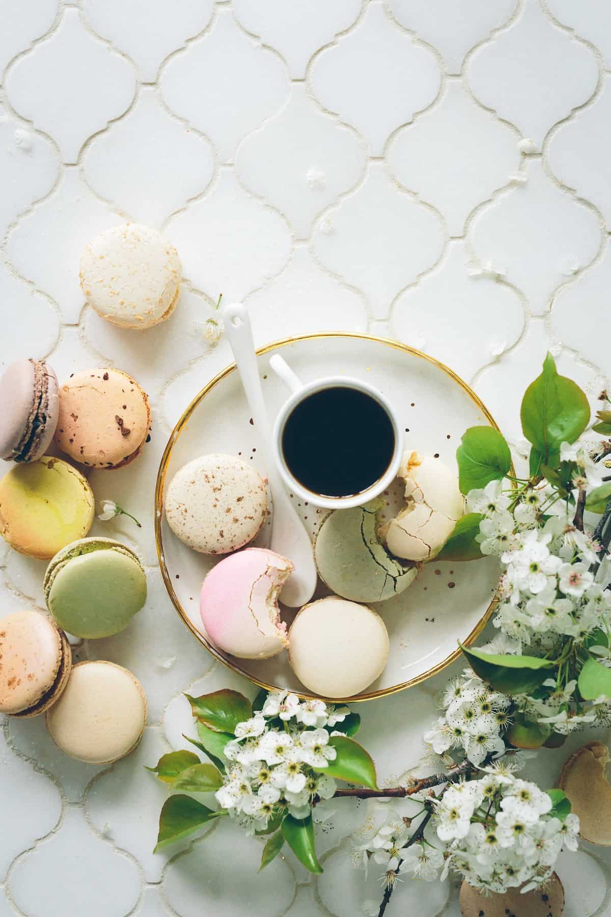 Cup of tea on a plate with macarons.