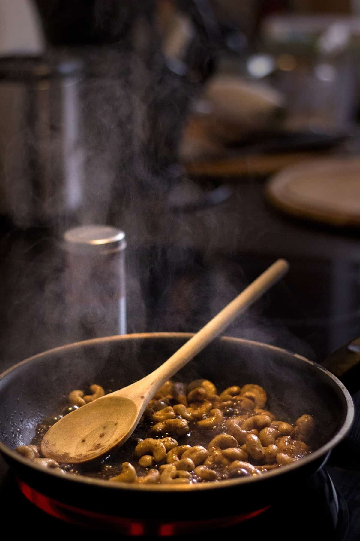 Wooden in a pan of cashews.