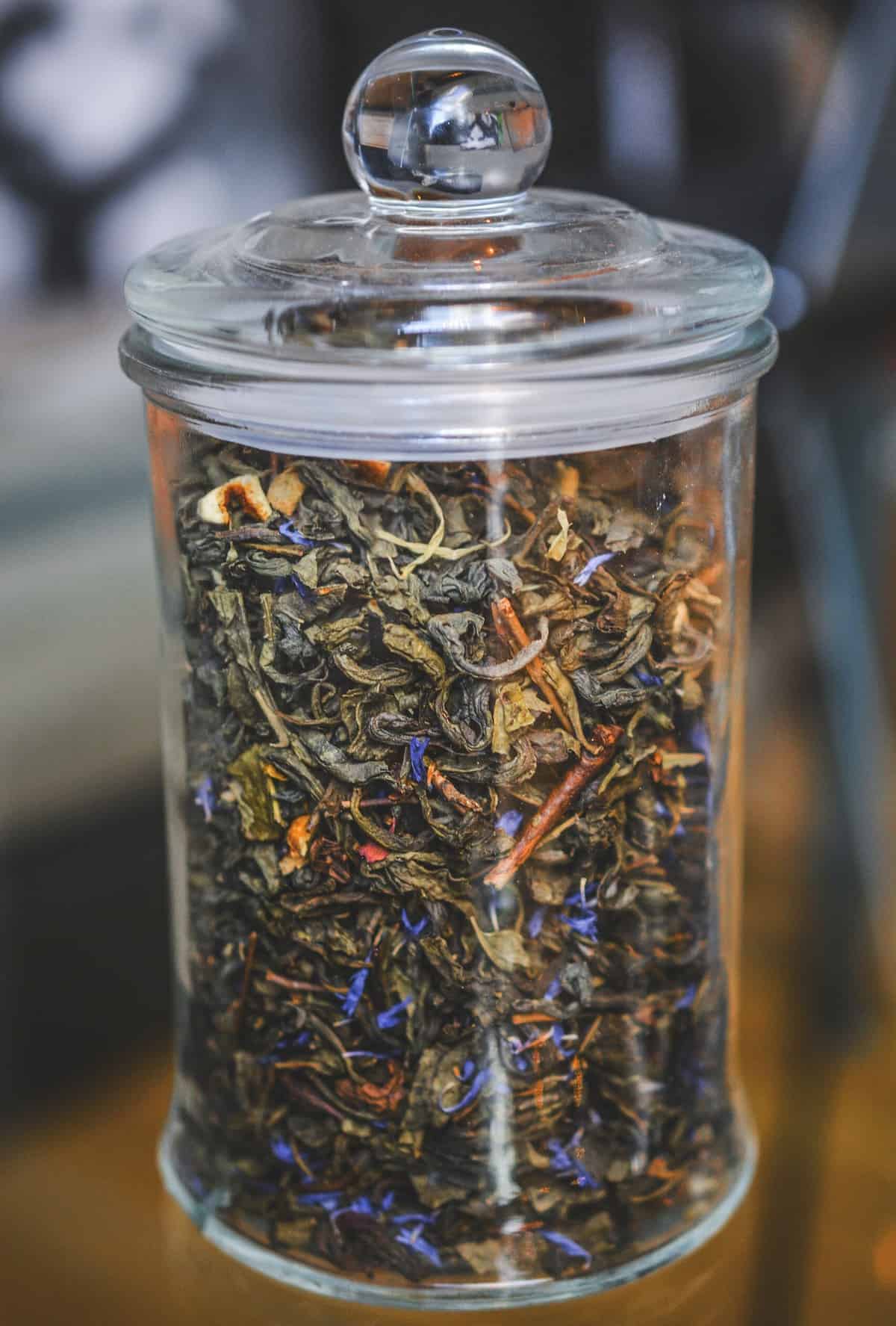 Dried tea in a glass container.