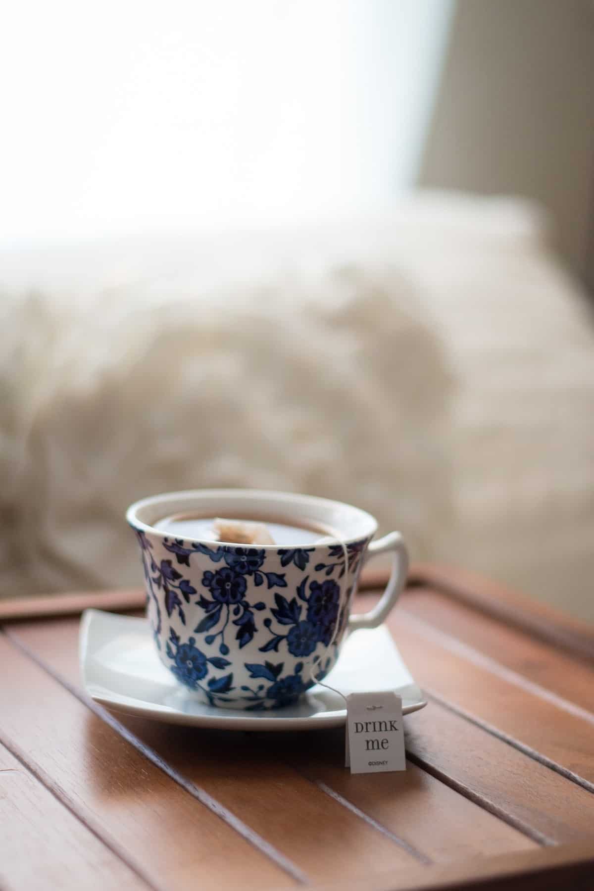 Blue and white floral cup filled with tea.