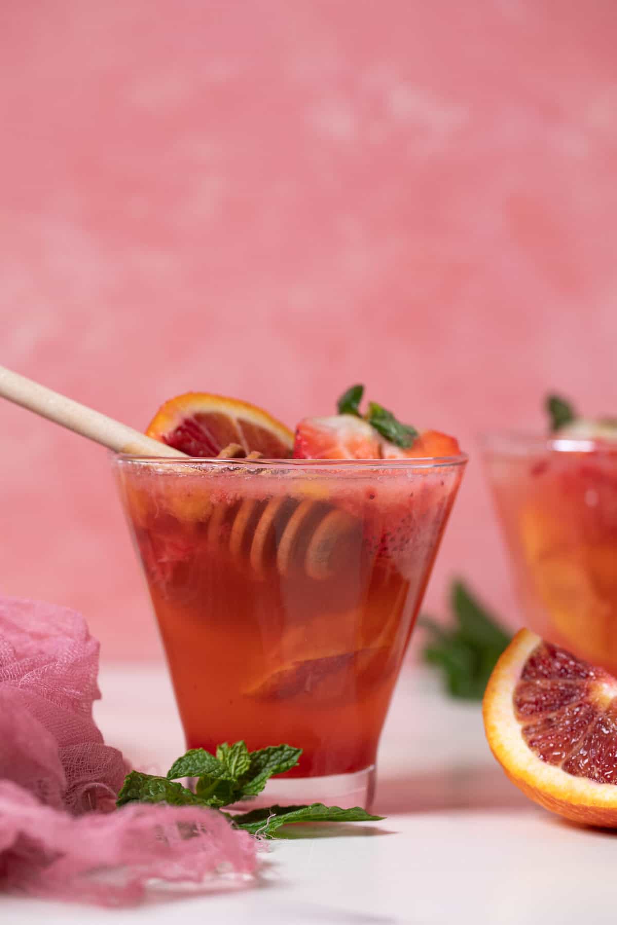 Honey dipper in a Blood Orange Strawberry Ginger Mocktail.
